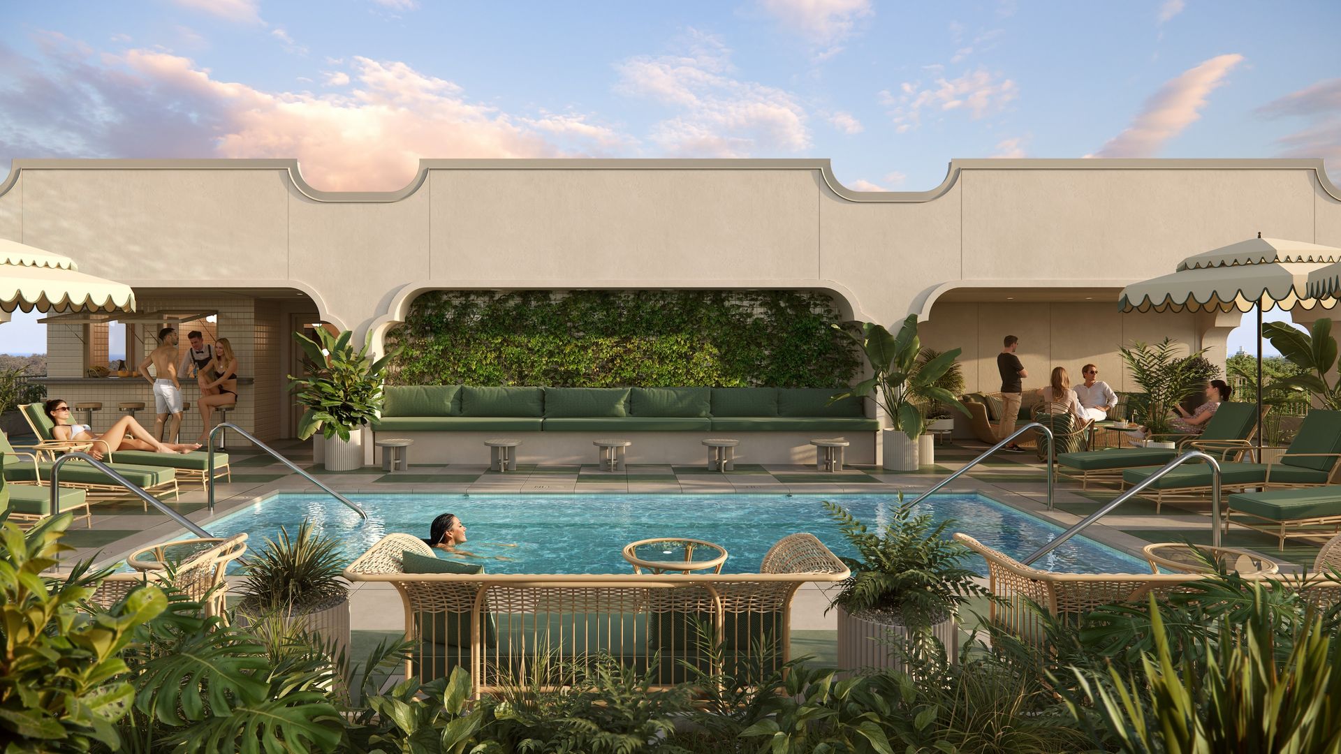 Outdoor pool area with people relaxing on green cushioned loungers and wicker furniture, surrounded by potted plants and beige building with arches under a blue sky with clouds.