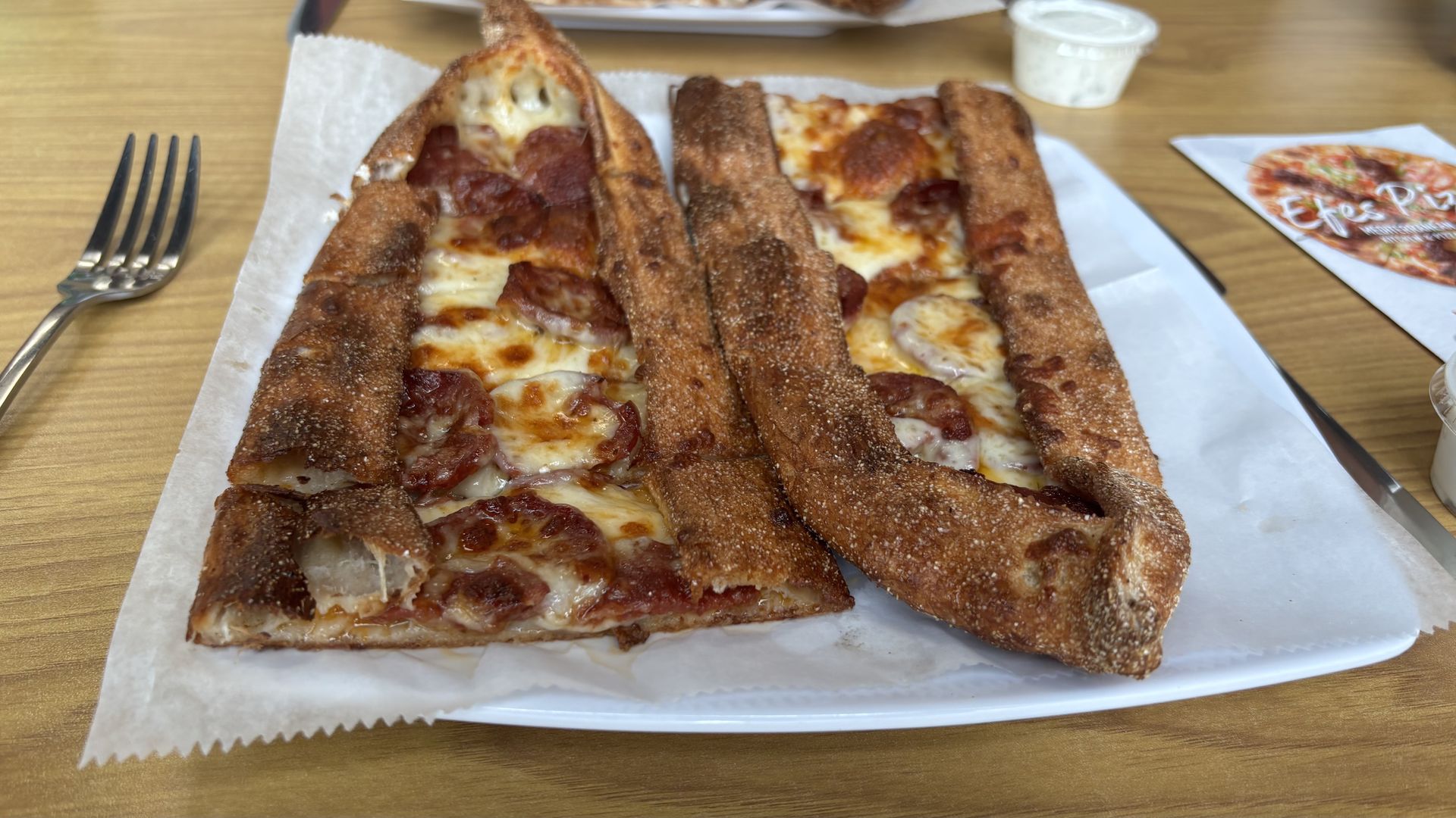 A Turkish pizza known as pide, with cheese and Turkish pepperoni called sujuk. Served at Efes Pizza in Aspinwall, Pa.