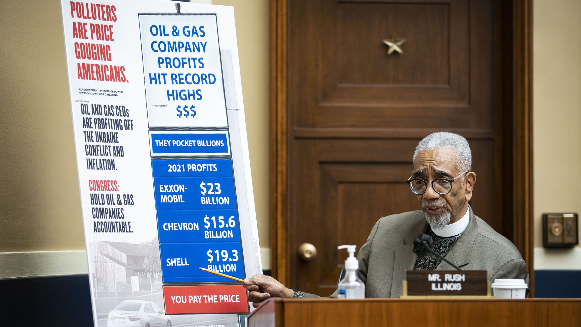 Rep. Bobby Rush is seen next to a chart showing oil company profits amid his gasoline prices.
