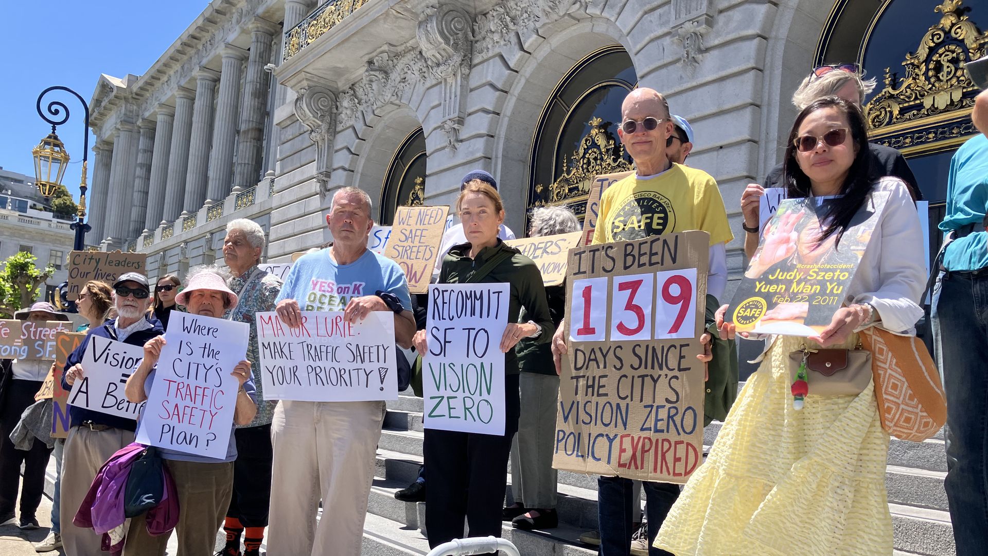 Street safety advocates rally in front of City Hall.