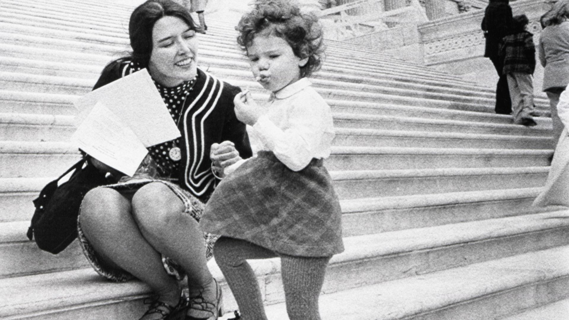 Rep. Pat Schroeder, D-Colo., was one of the many working mothers who brought their children to the office 4/10 to protest cutbacks in federally-funded day care centers. Reps Schroeder is shown on the steps of the Capitol with her daughter, Jamie, 2 ½ years old. 	April 10, 1973