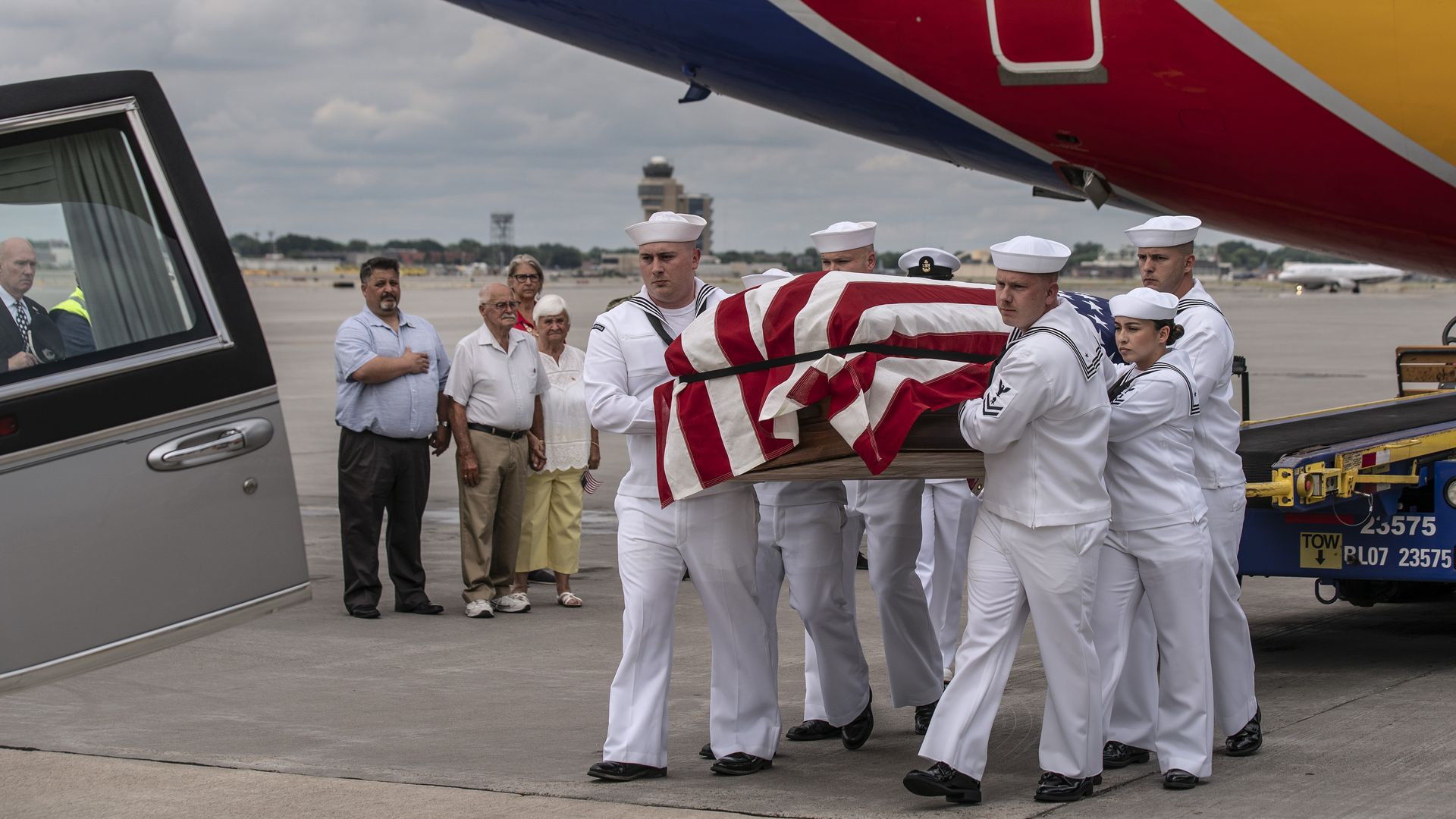 Neal Todd's remains, in a casket, are carried by members of the Navy 