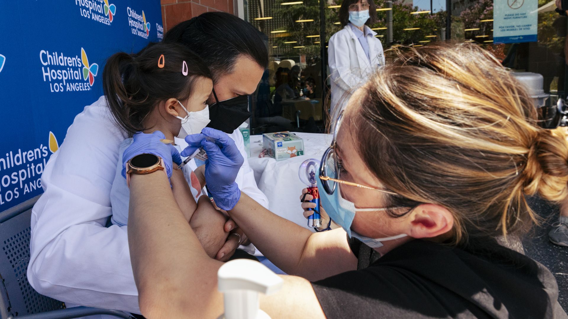 Sofia Espinoza Tam and Dr. Juan Espinoza, while CHLA nurse Monica Lopez administers the Pfizer COVID-19 vaccine outside the hospital on Tuesday, June 21, 2022 in Los Angeles, CA. 