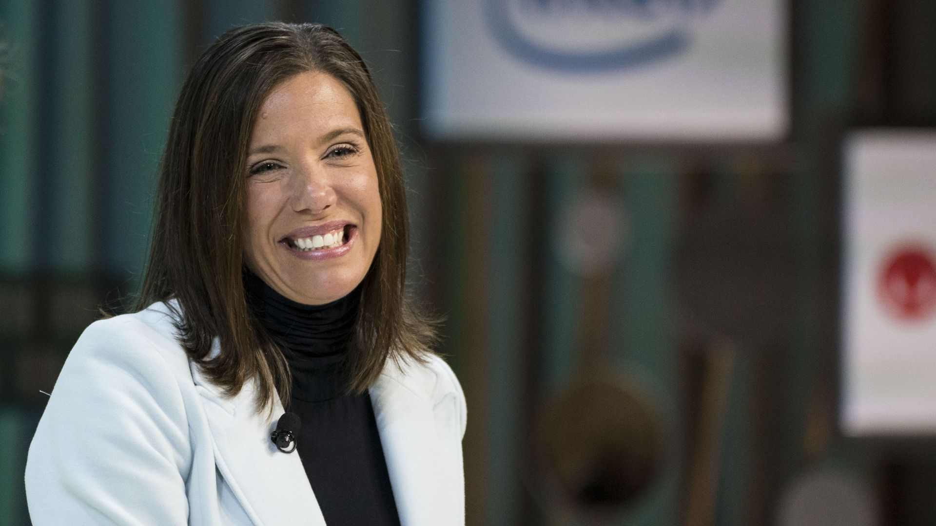 A  photo of Corie Barry wearing a white jacket 