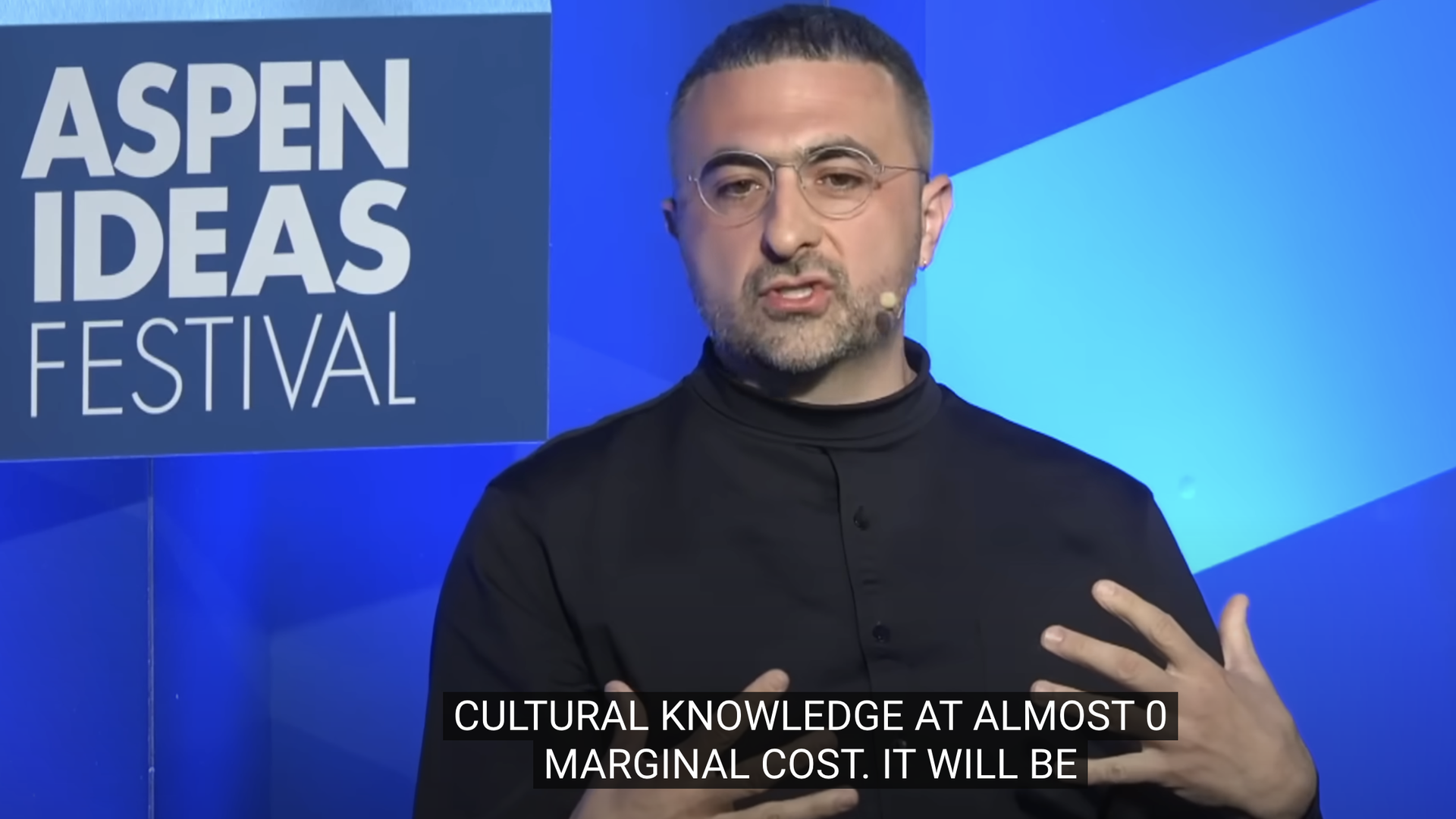 Screenshot of Mustafa Suleyman in a black shirt talking at the Aspen Ideas Festival