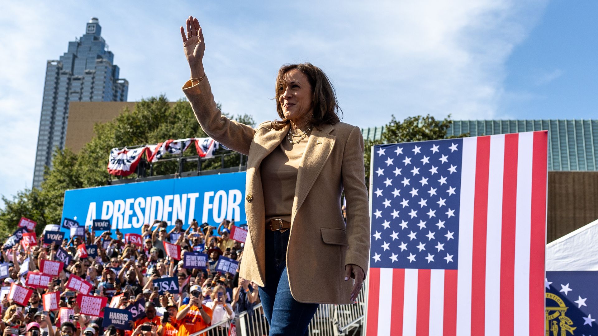 Kamala Harris waves to a crowd at a rally.