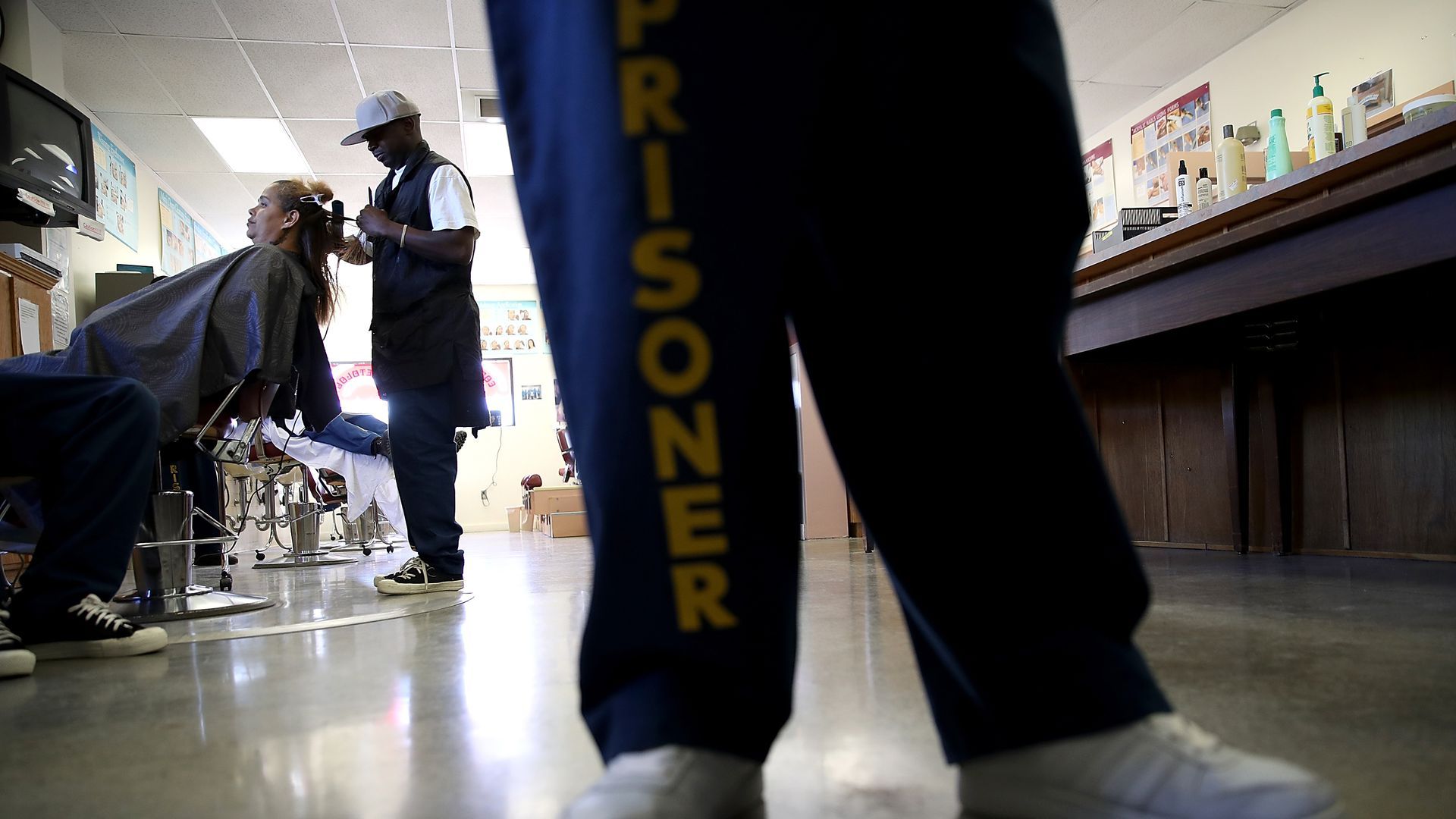 Convict with "prisoner" pants in a barbershop