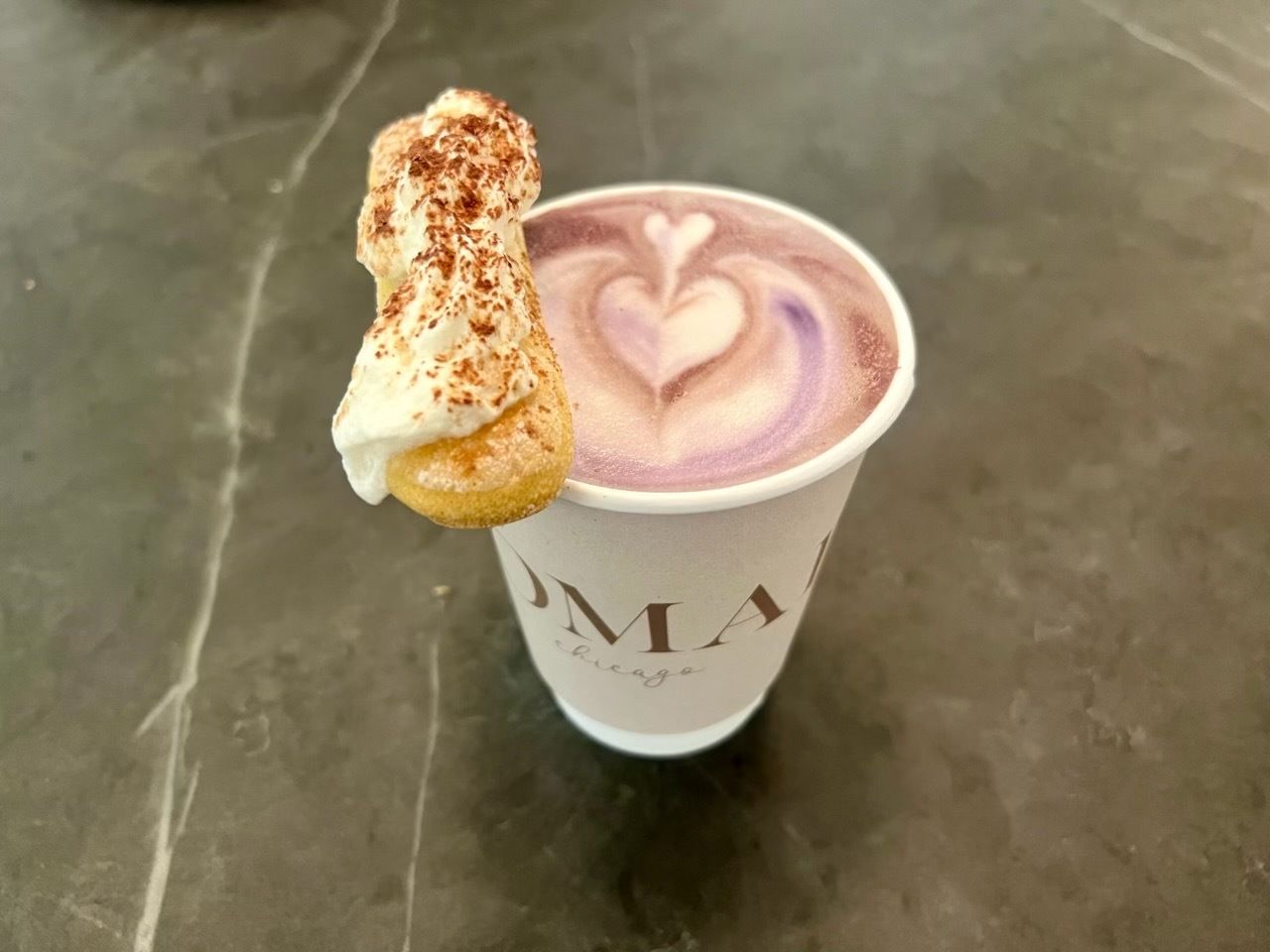 Photo of a cup of coffee with a cookie 