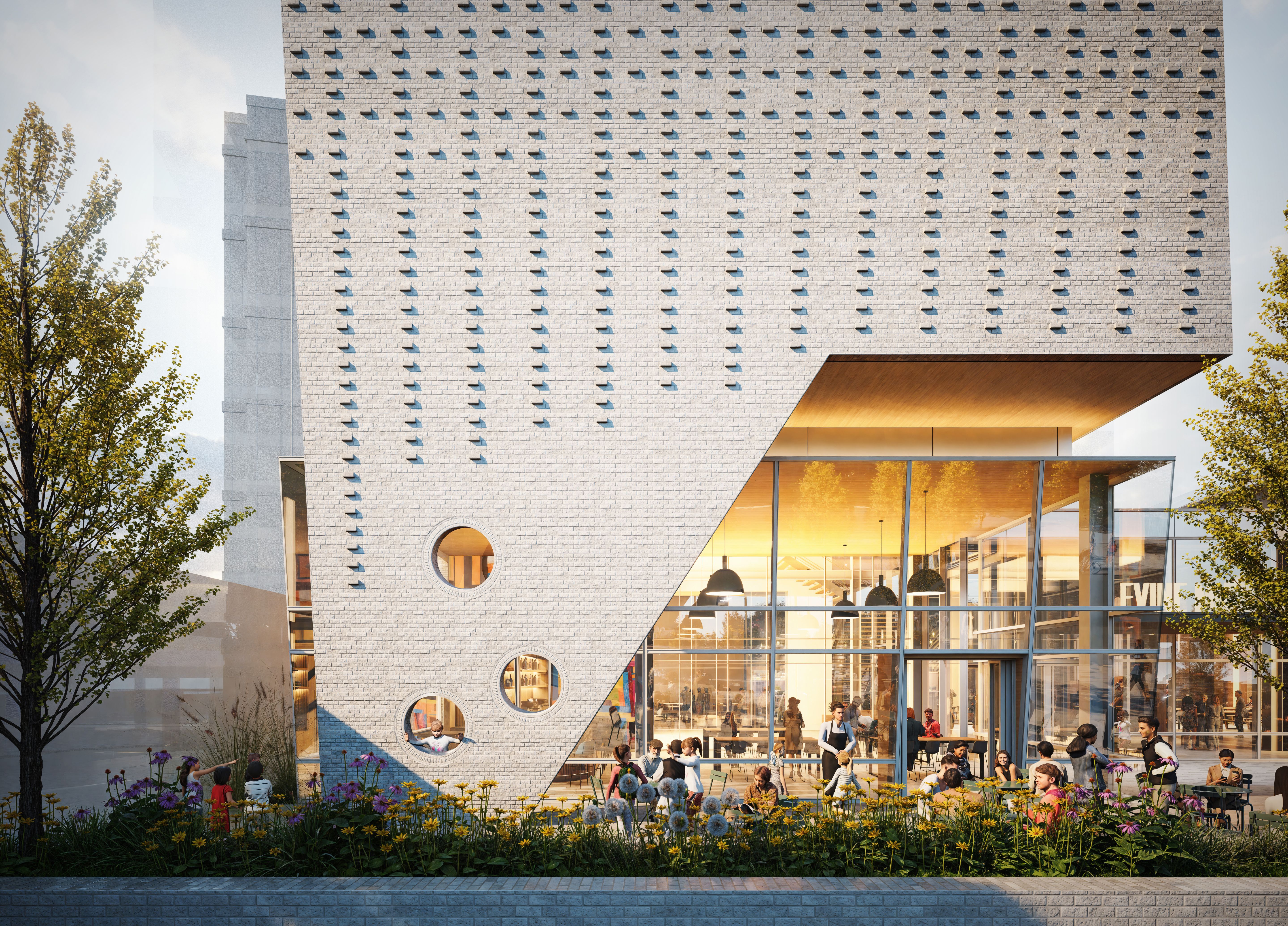 Modern white brick building with an angled wall and circular windows, glass front revealing people dining inside, outdoor garden with yellow and purple flowers, and trees on both sides.