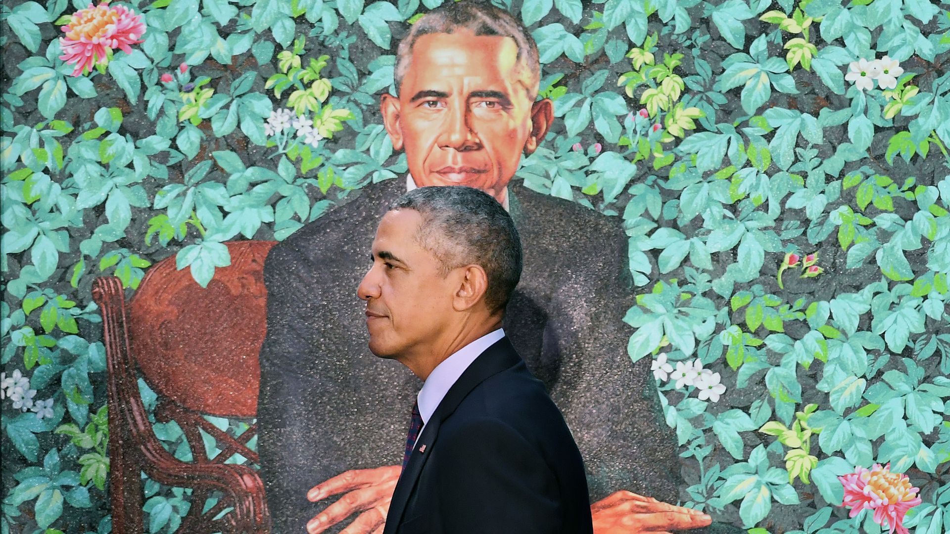 Barack Obama walking past his official portrait 