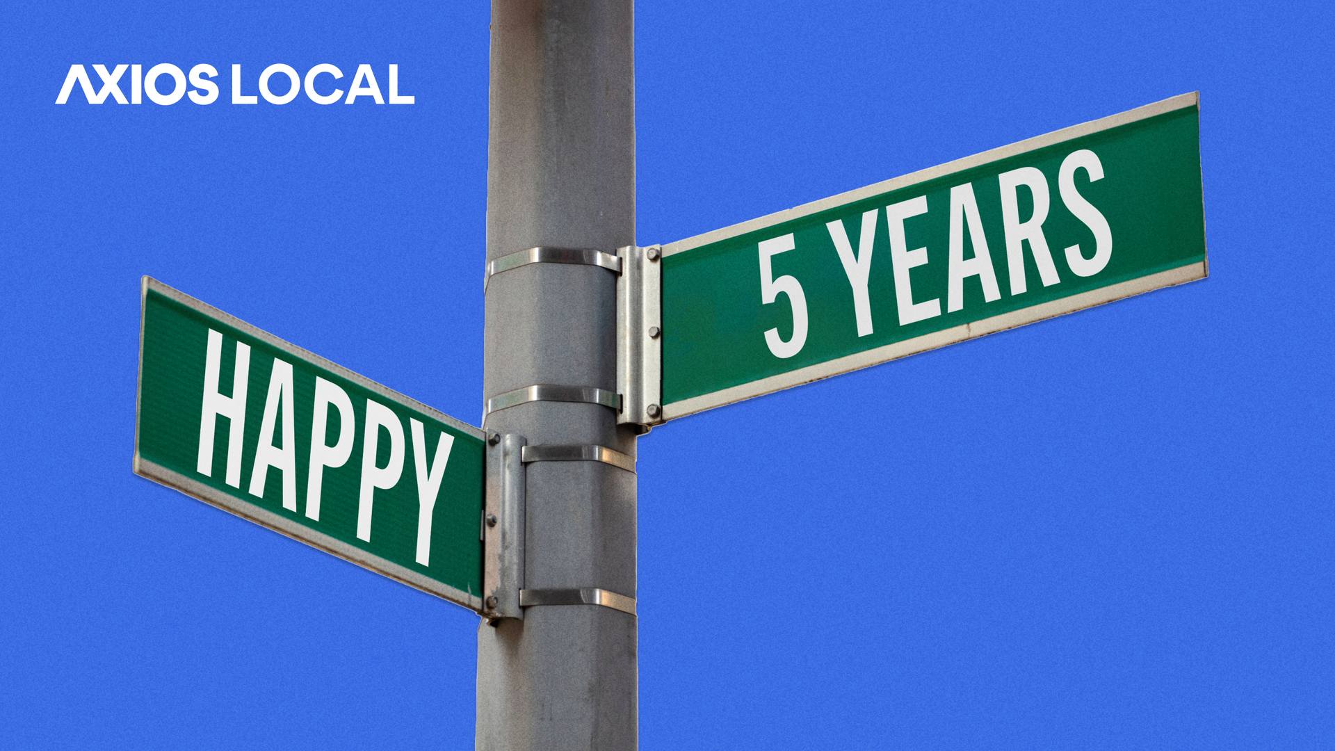 Intersecting street sign reflecting Happy 5 Years for Axios Local.