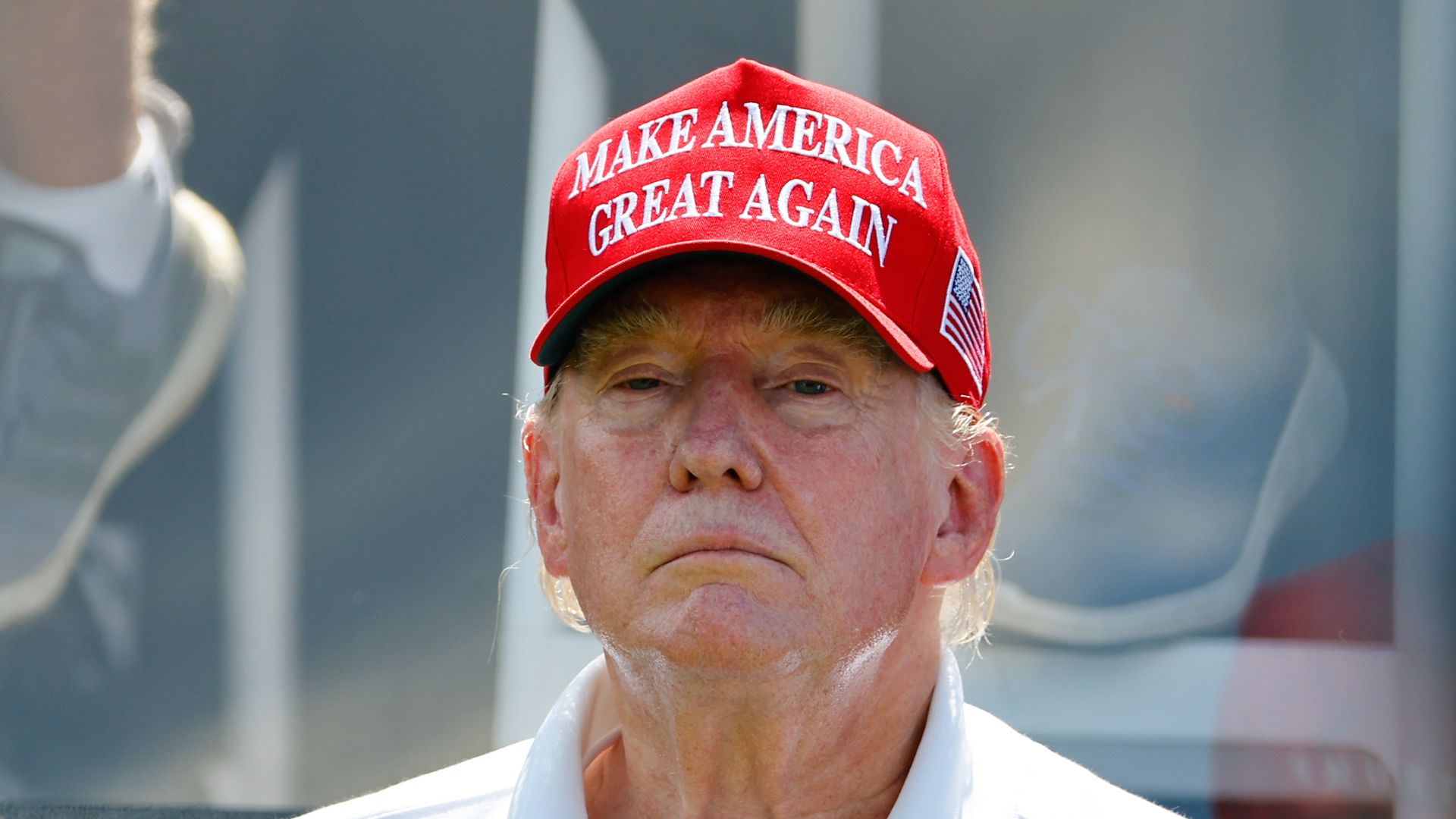 Former President Trump in a red cap that says "Make America Great Again."
