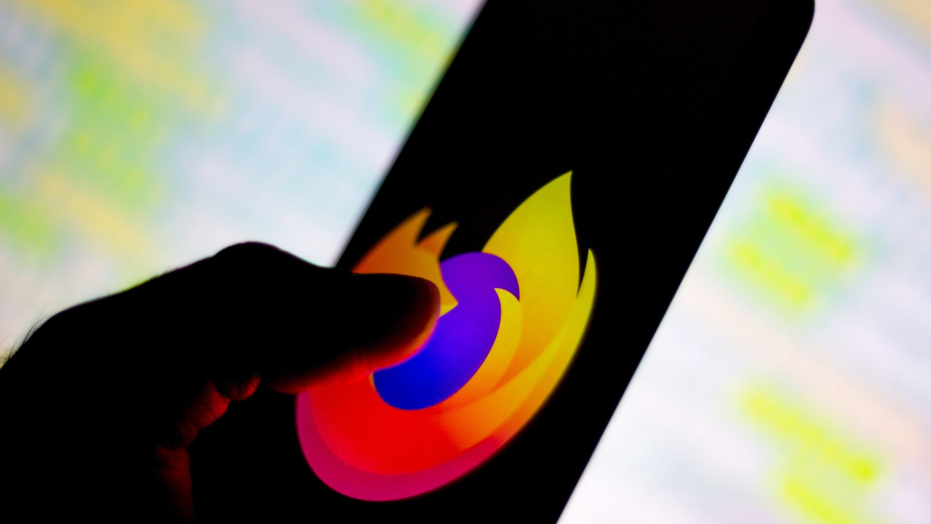 A photo of a smartphone with the Mozilla Firefox logo prominently displayed on it.