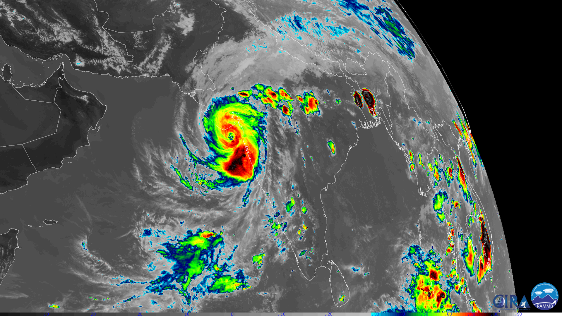 Satellite image showing a swirling storm with an eye at the center, crossing the Indian coast.