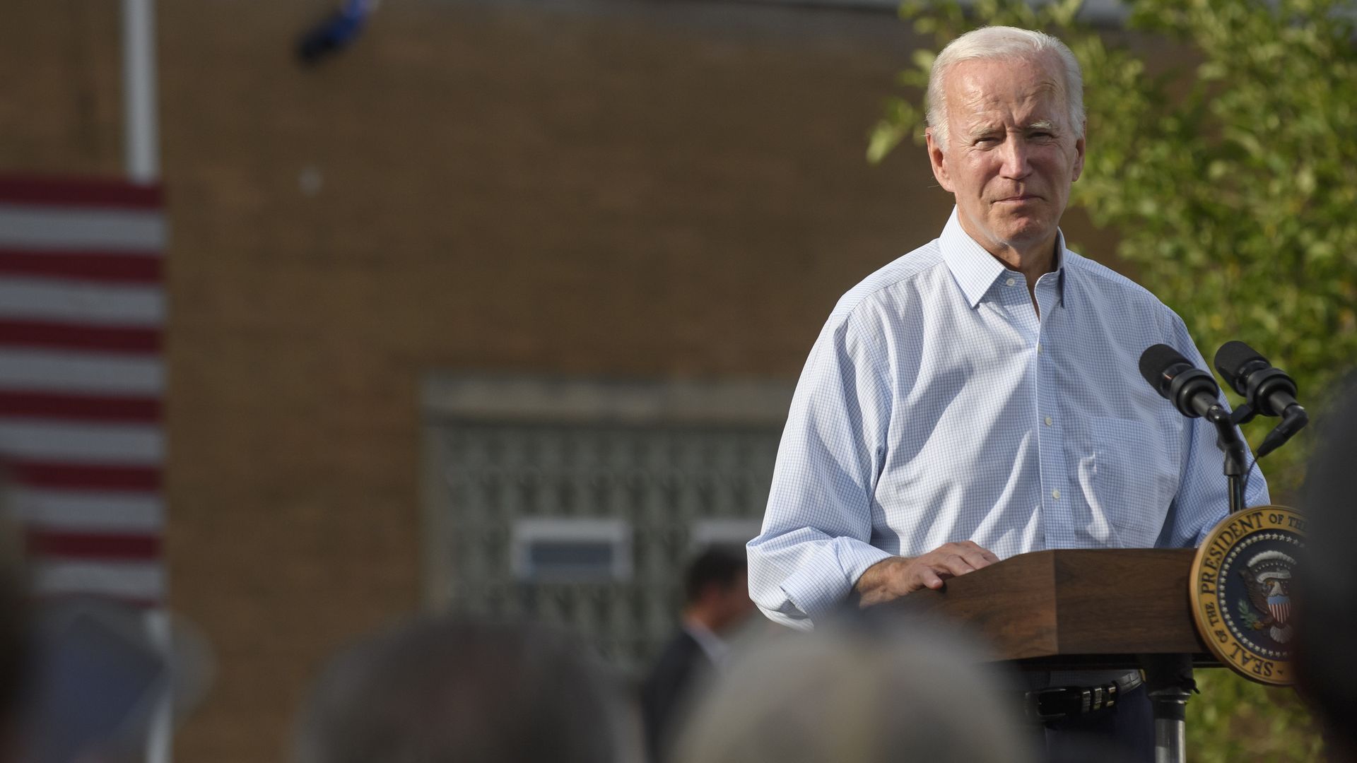 Photo of Joe Biden speaking from a podium in an outdoor venue