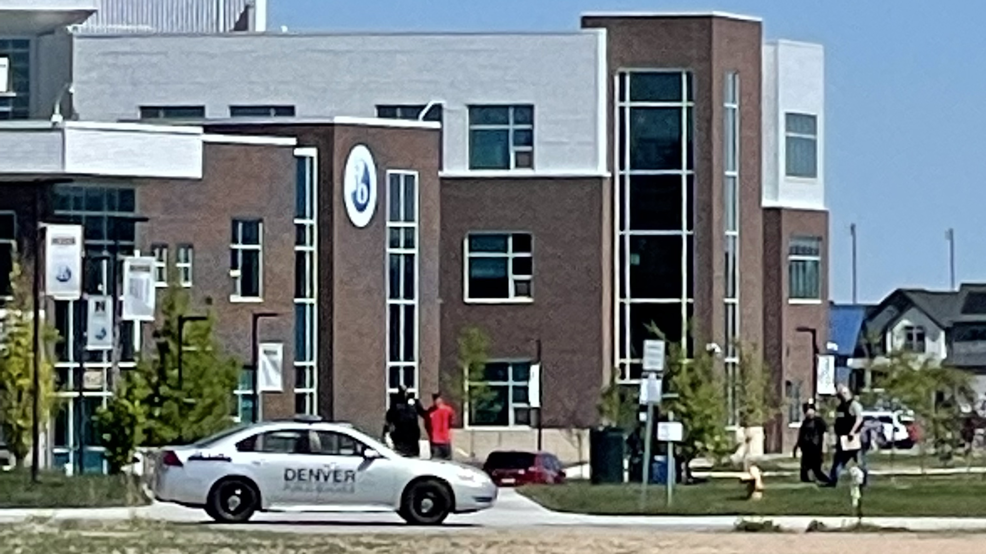 Authorities take a person into custody outside Northfield High School in Denver on May 26, 2022. Photo: Esteban L. Hernandez