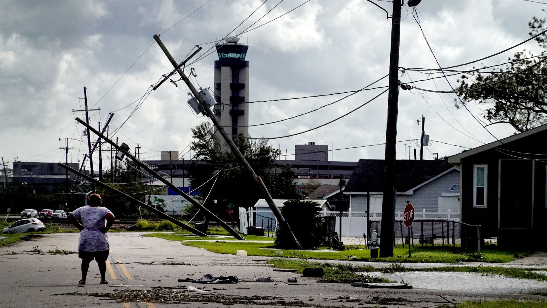A woman looks over damage caused by Hurricane Ida, Aug. 30, in Kenner, La. 