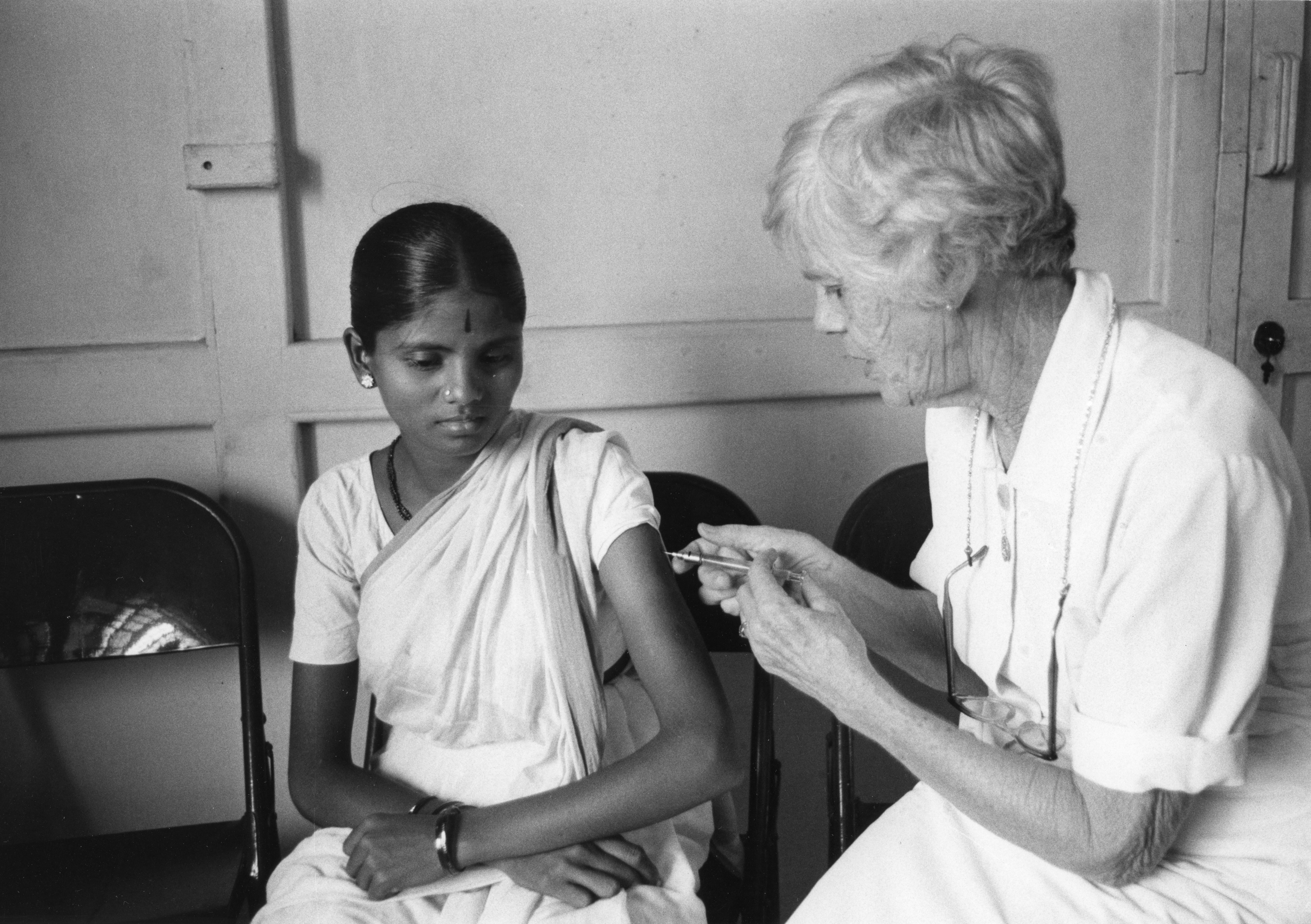 Peace Corps volunteer (and mother of future US President Jimmy Carter) Lillian Gordy Carter (1898 - 1983) administers an injection (presumably a vaccine) to a young girl in a clinic, Godrej Colony, India, June 1968. (Photo by Vern Richey/Peace Corps/National Archives and Records Administration/PhotoQuest/Getty Images)