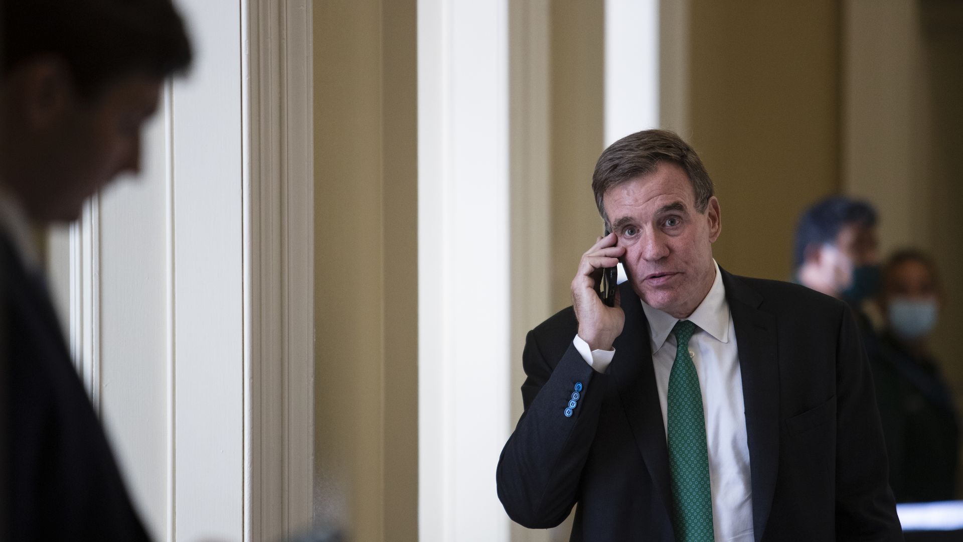 Sen. Mark Warner is seen speaking on a cellphone.