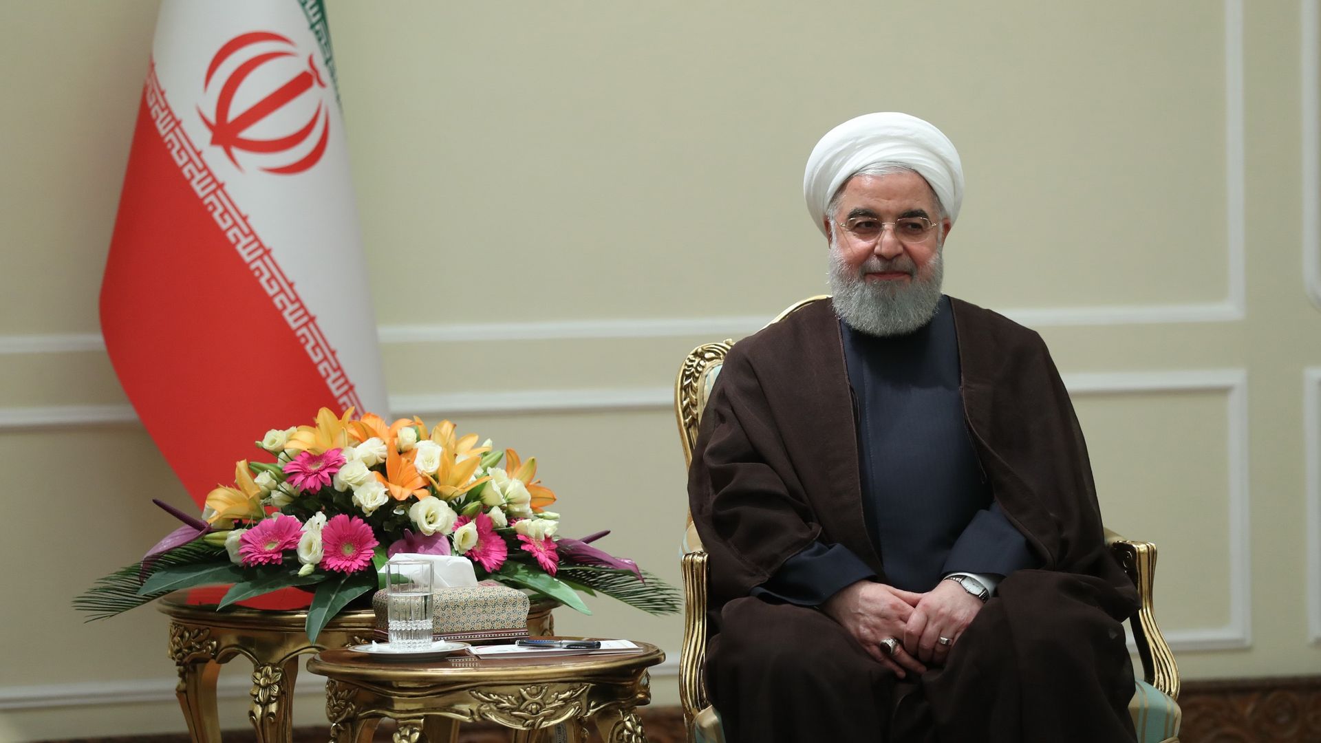Hassan Rouhani seated in a chair