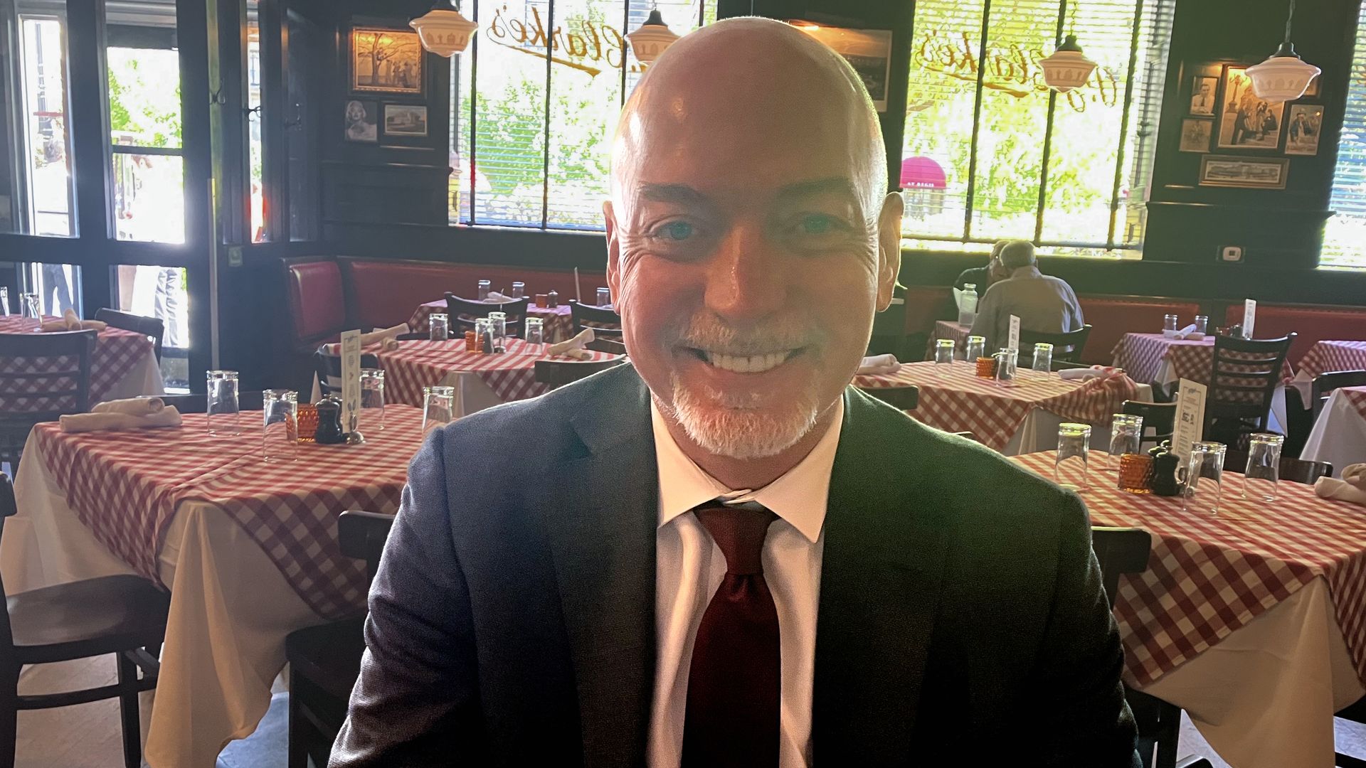 Joel White sits at a restaurant eating lunch
