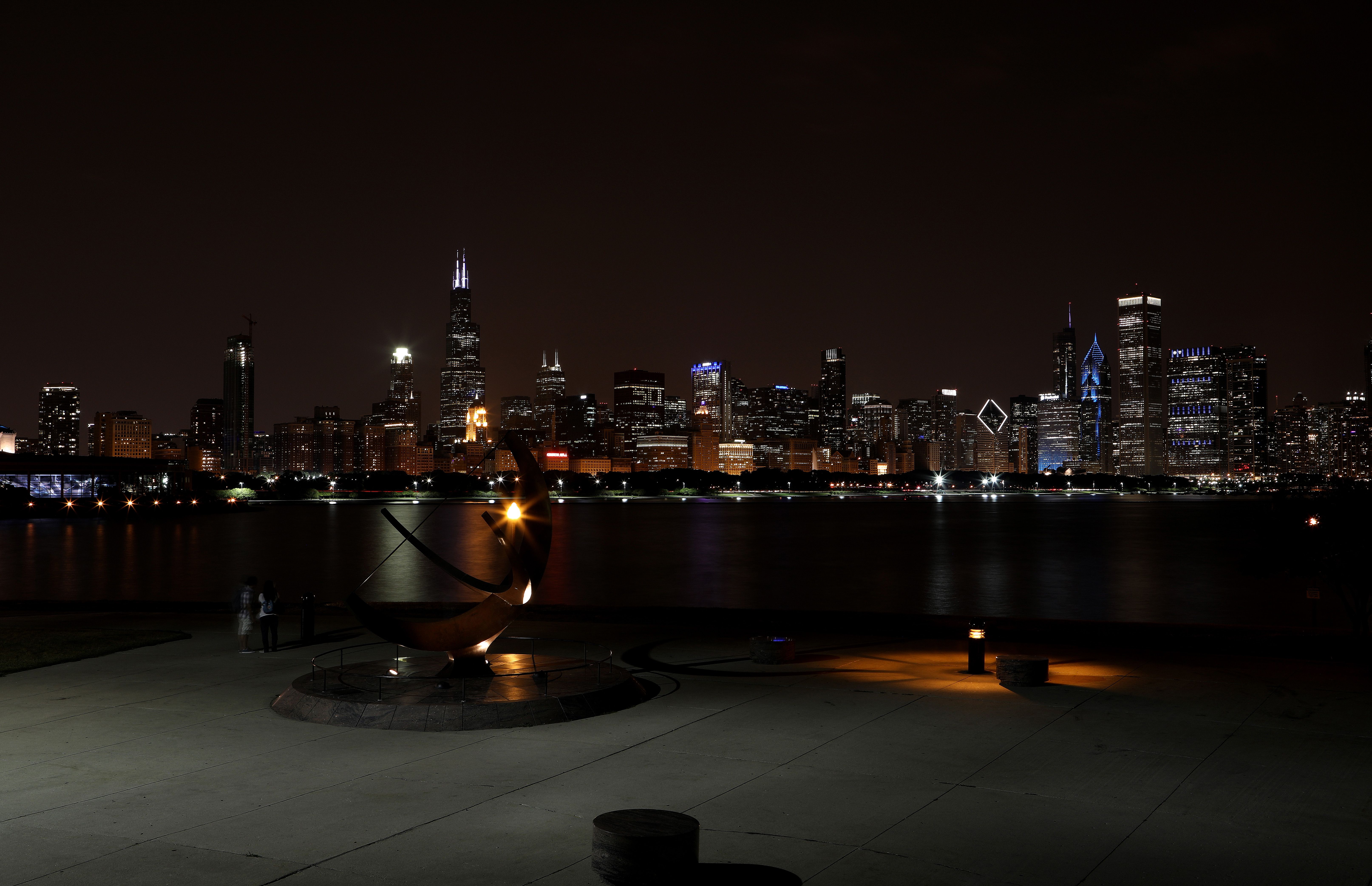 Chicago skyline at night, with sundial in front