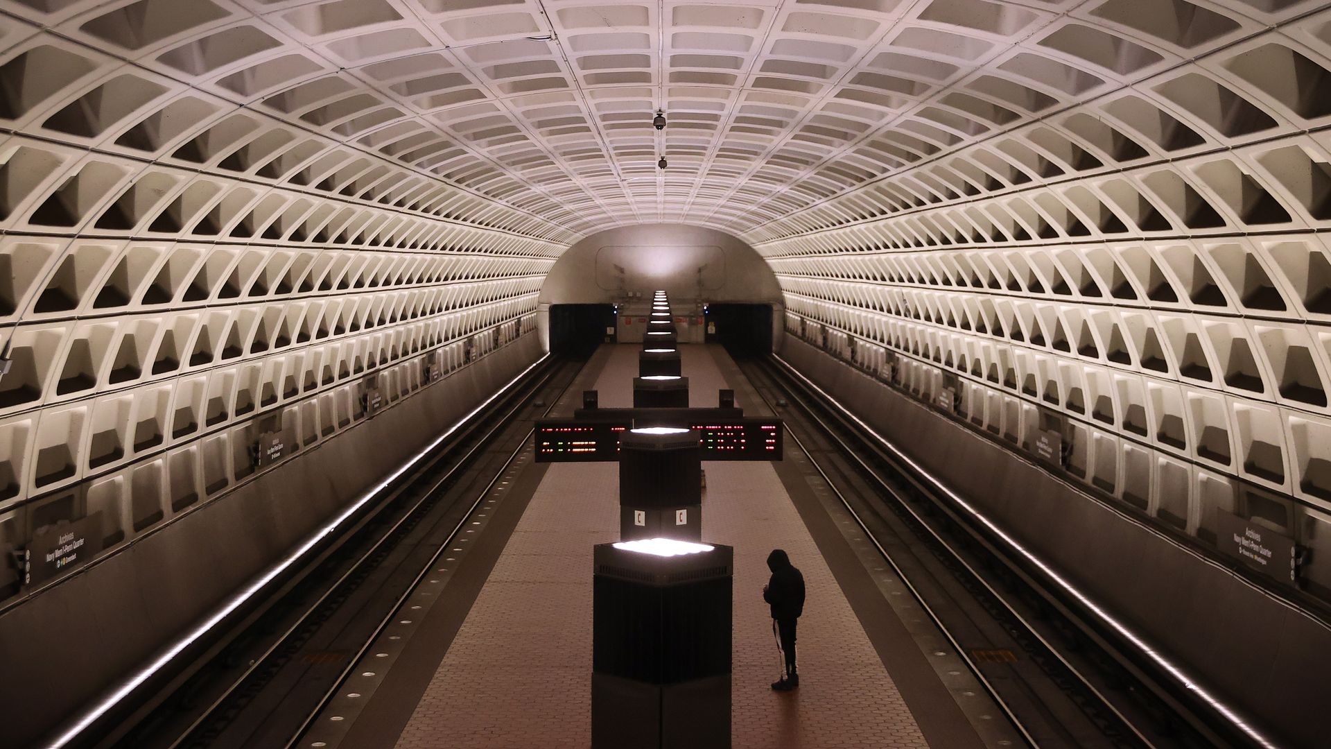One passenger waits inside an empty Metro station.