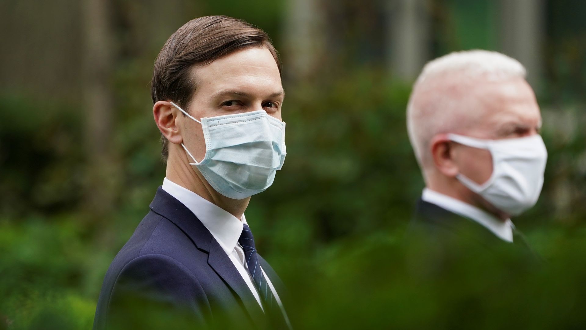 Jared Kushner and Adm. Brett Giroir, the federal official overseeing testing, wear masks at the White House during President Trump's news conference this afternoon. Photo: Kevin Lamarque/Reuters