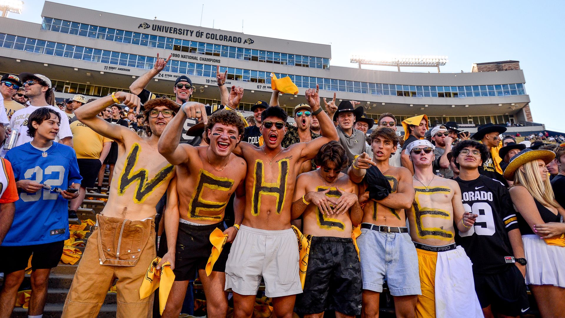 CU football fans wear paint reading "We Here" as they cheer from the student section at the Saturday game against the Nebraska Cornhuskers. Photo: Dustin Bradford/Getty Images