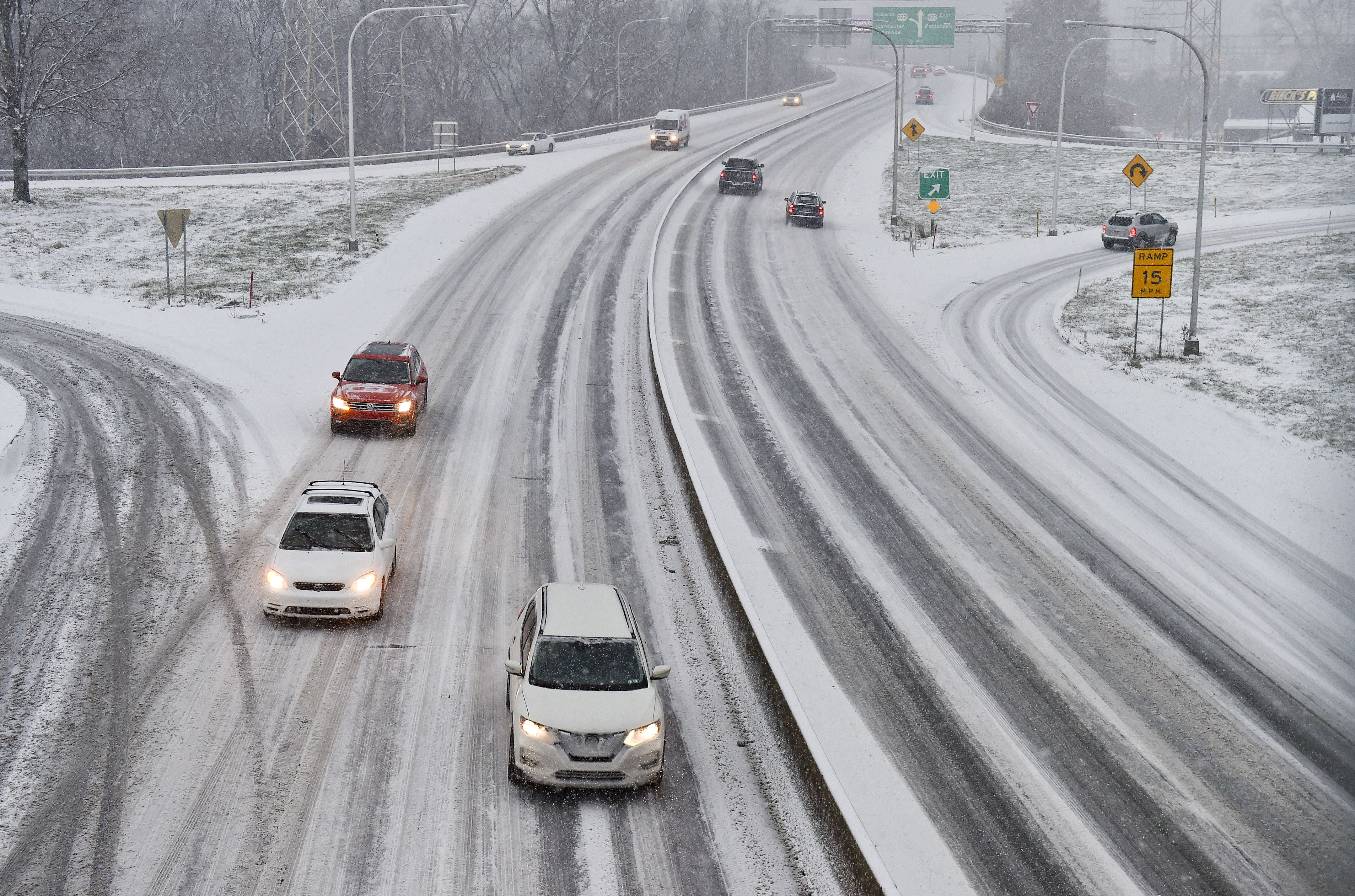 Cars drive on a snow covered Route 422 at the Penn Street Cloverleaf in West Reading Wednesday afternoon December 16
