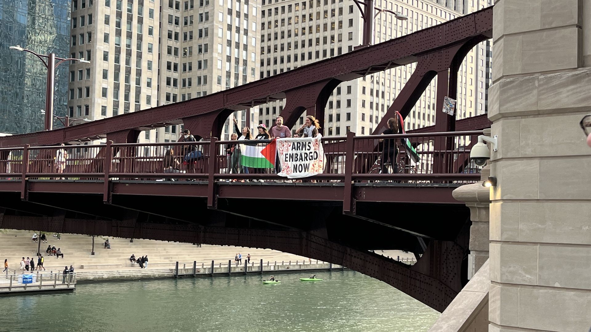 Photo of protest signs hanging over a bridge 