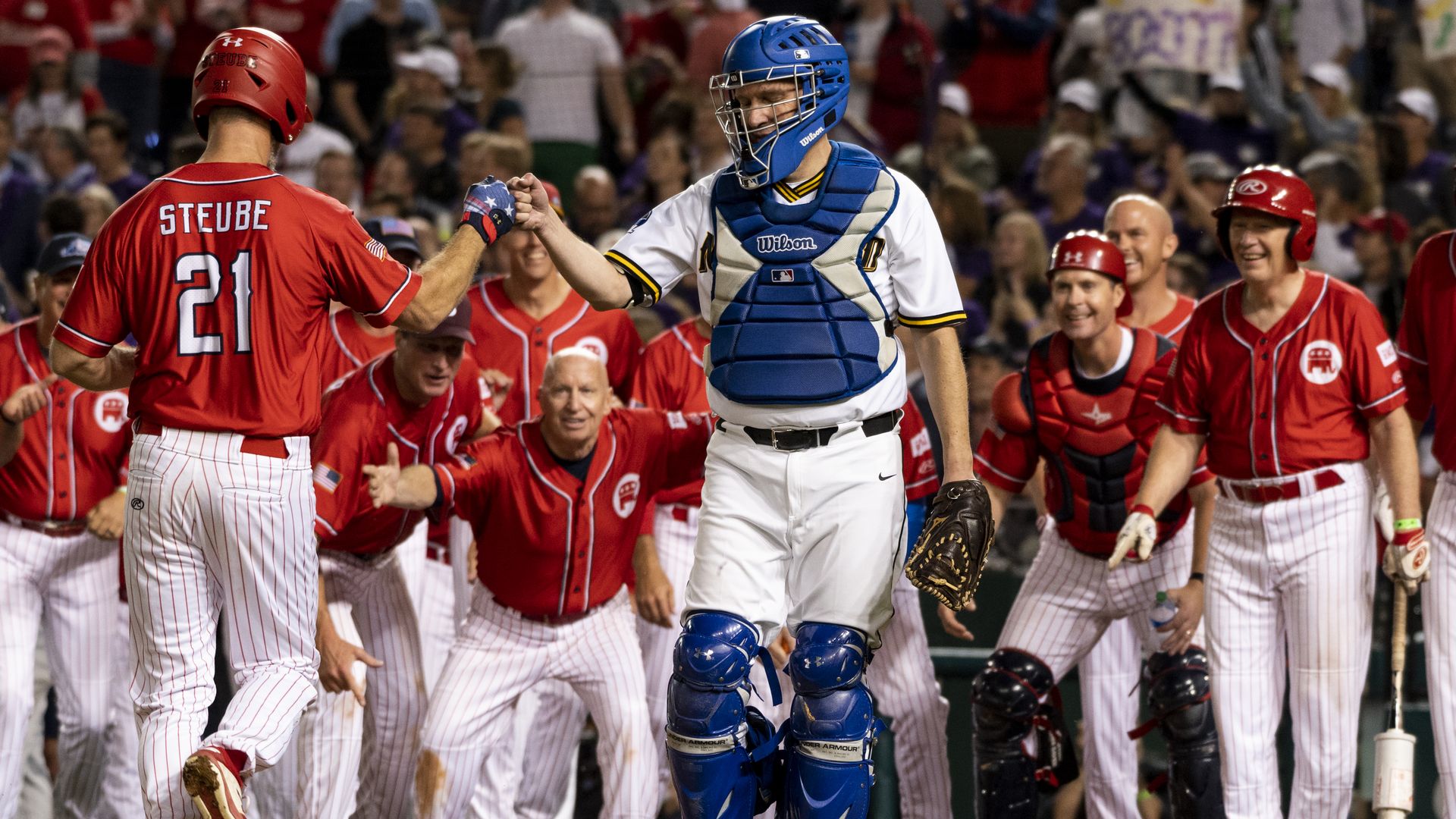 Rep. Greg Steube (R-Fla.) fist bumping Sen. Chris Murphy (D-Conn.) during the 2021 Congressional Baseball Game in Washington, D.C.