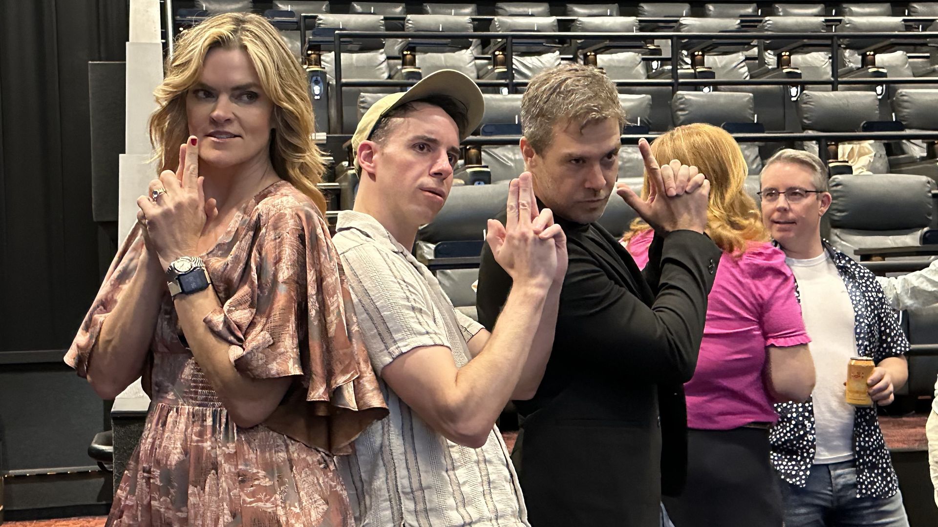 Actress Missi Pyle, Gerry D'Apollo and director Matt Kugelman pose for a photo with their hands like guns, like secret agents, at the Alamo Drafthouse in Boston.