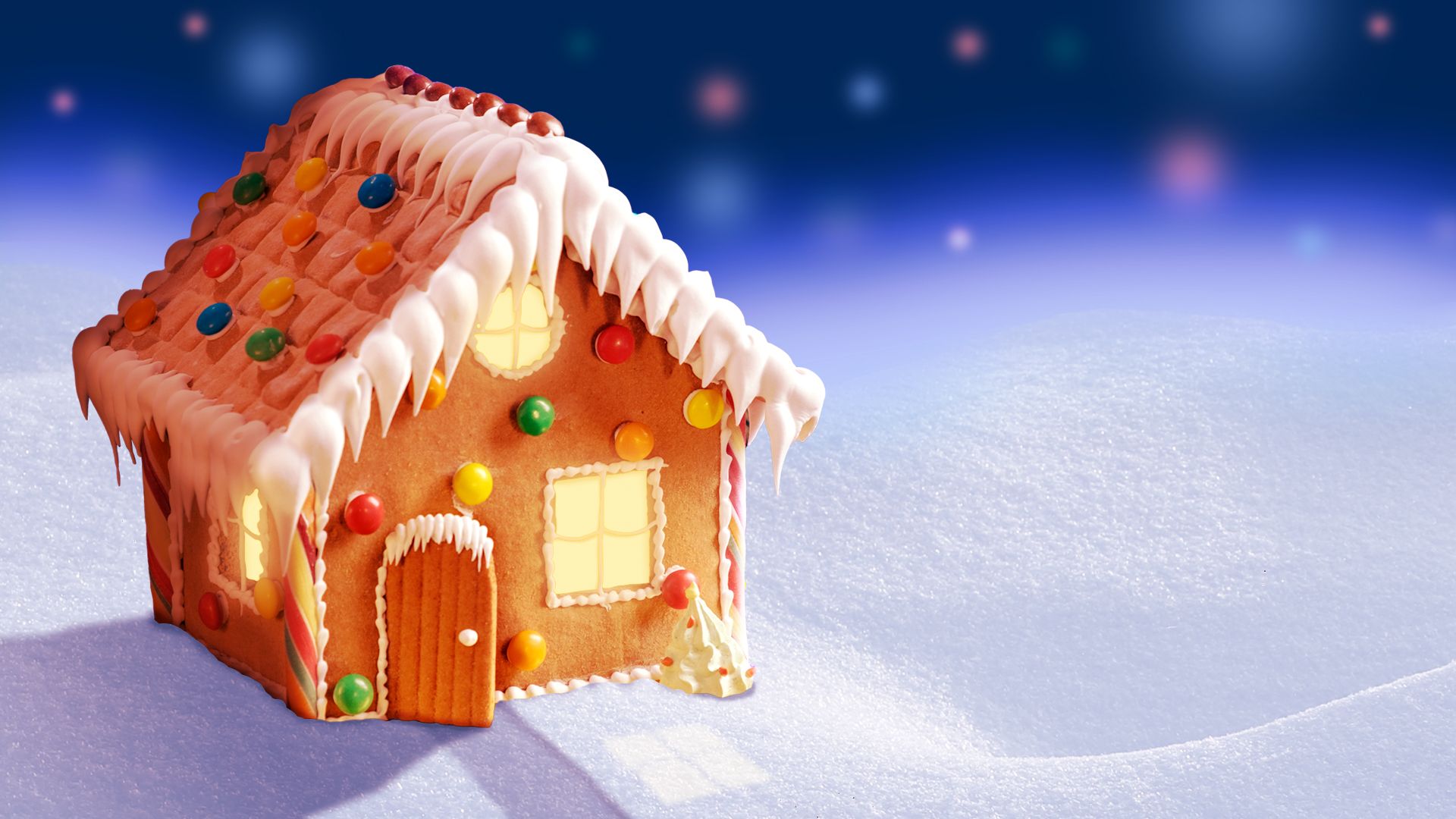 Illustration of a lit up gingerbread house in a wintery landscape