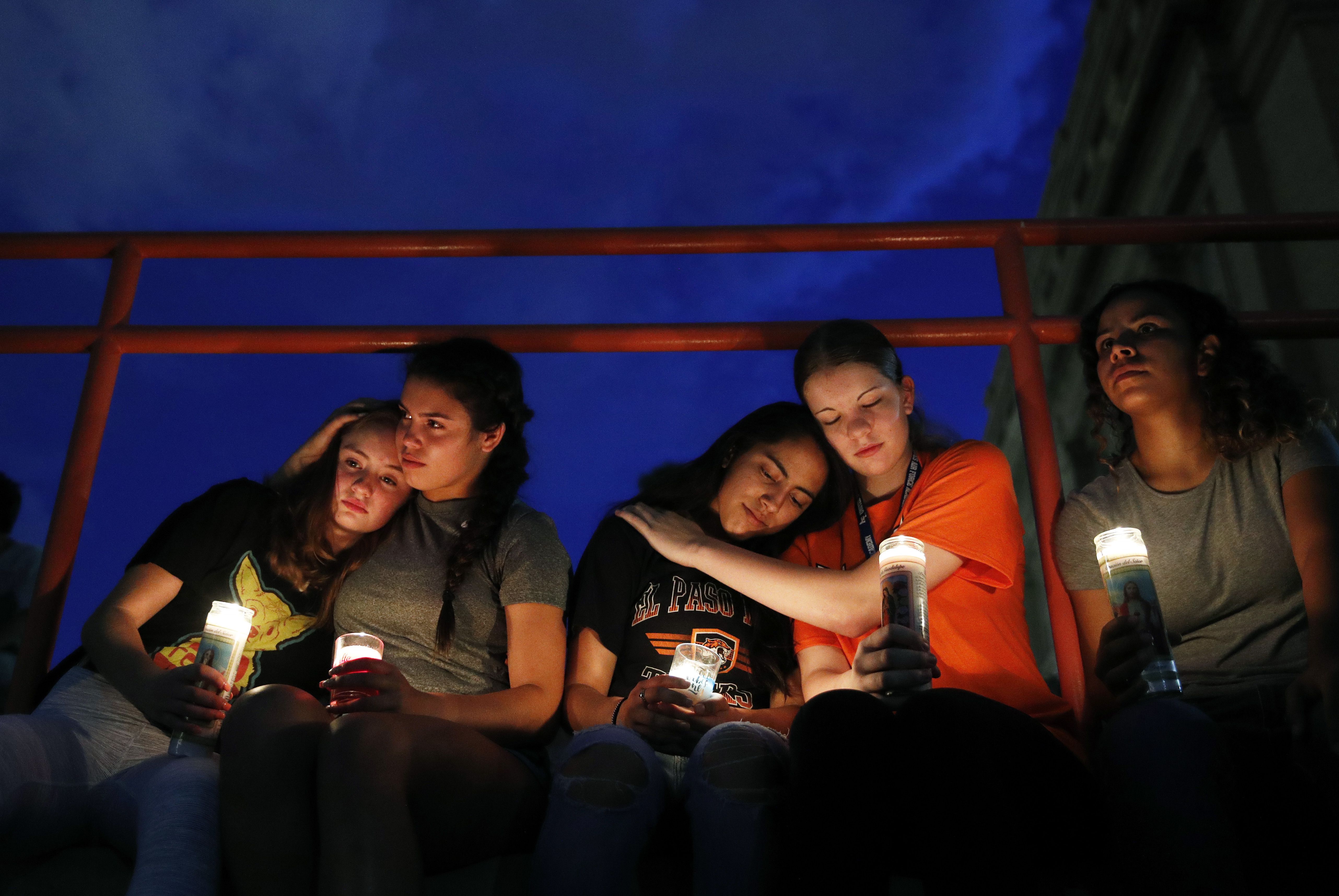 Melody Stout, Hannah Payan, Aaliyah Alba, Sherie Gramlich and Laura Barrios comfort each other during a vigil for victims of the shooting Saturday, Aug. 3, 2019, in El Paso, Texas. 