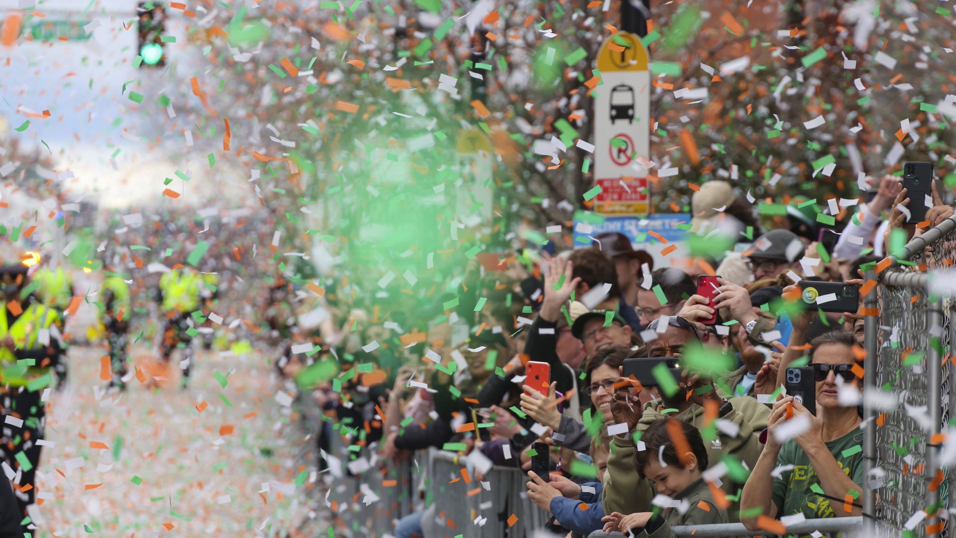 Confetti flies after Gov. Charlie Baker and Boston Mayor Michelle Wu cut the opening ribbon to start Bostons St. Patricks Day Parade in South Boston on March 20, 2022. 