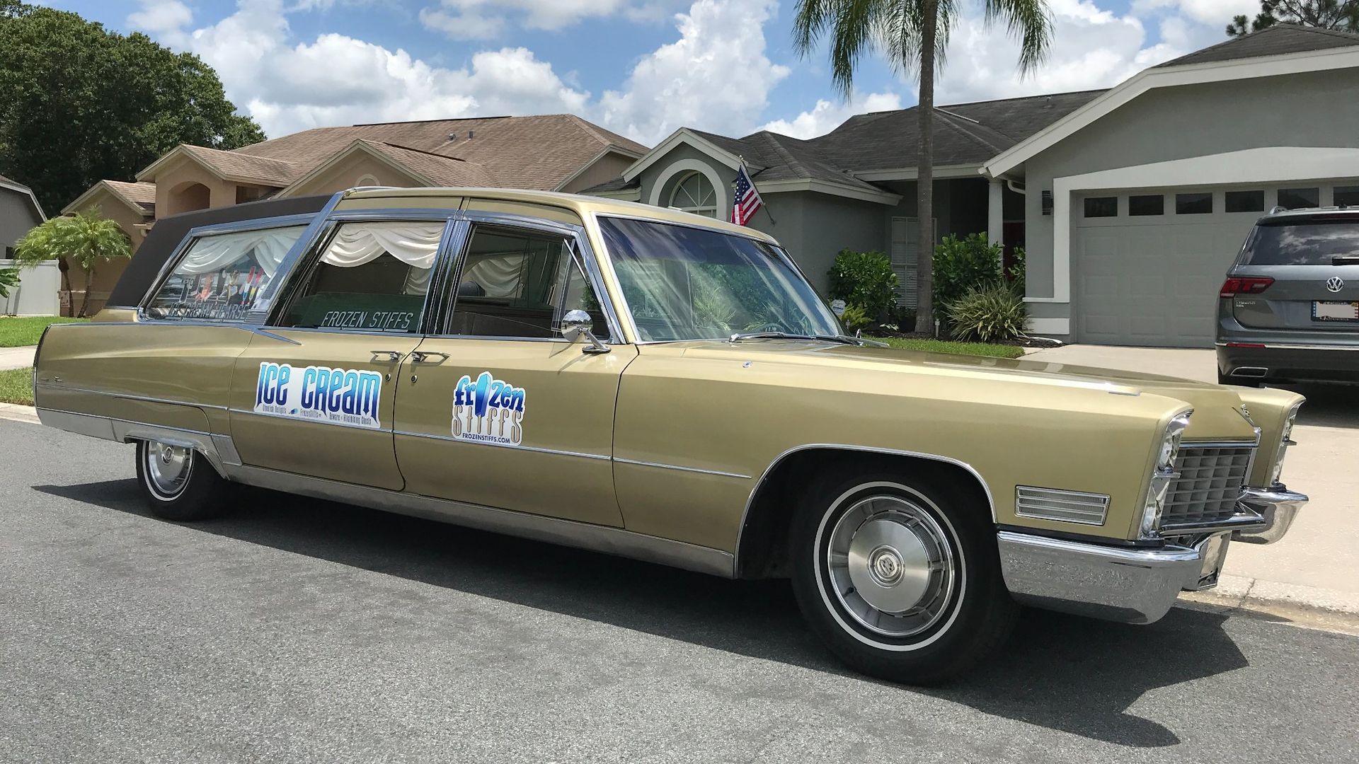 A gold hearse with the Frozen Stiffs logo on the side door.