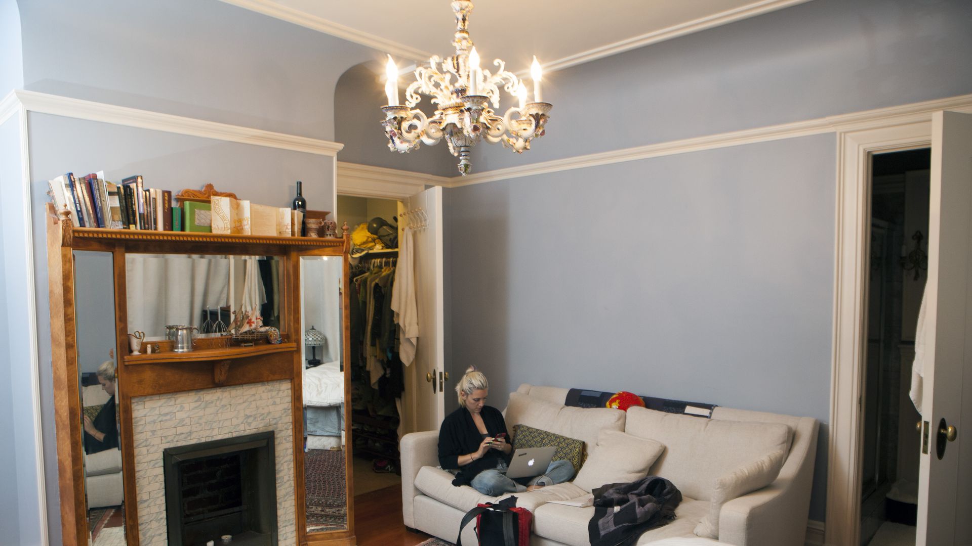 Woman sitting in living room on a couch with her laptop