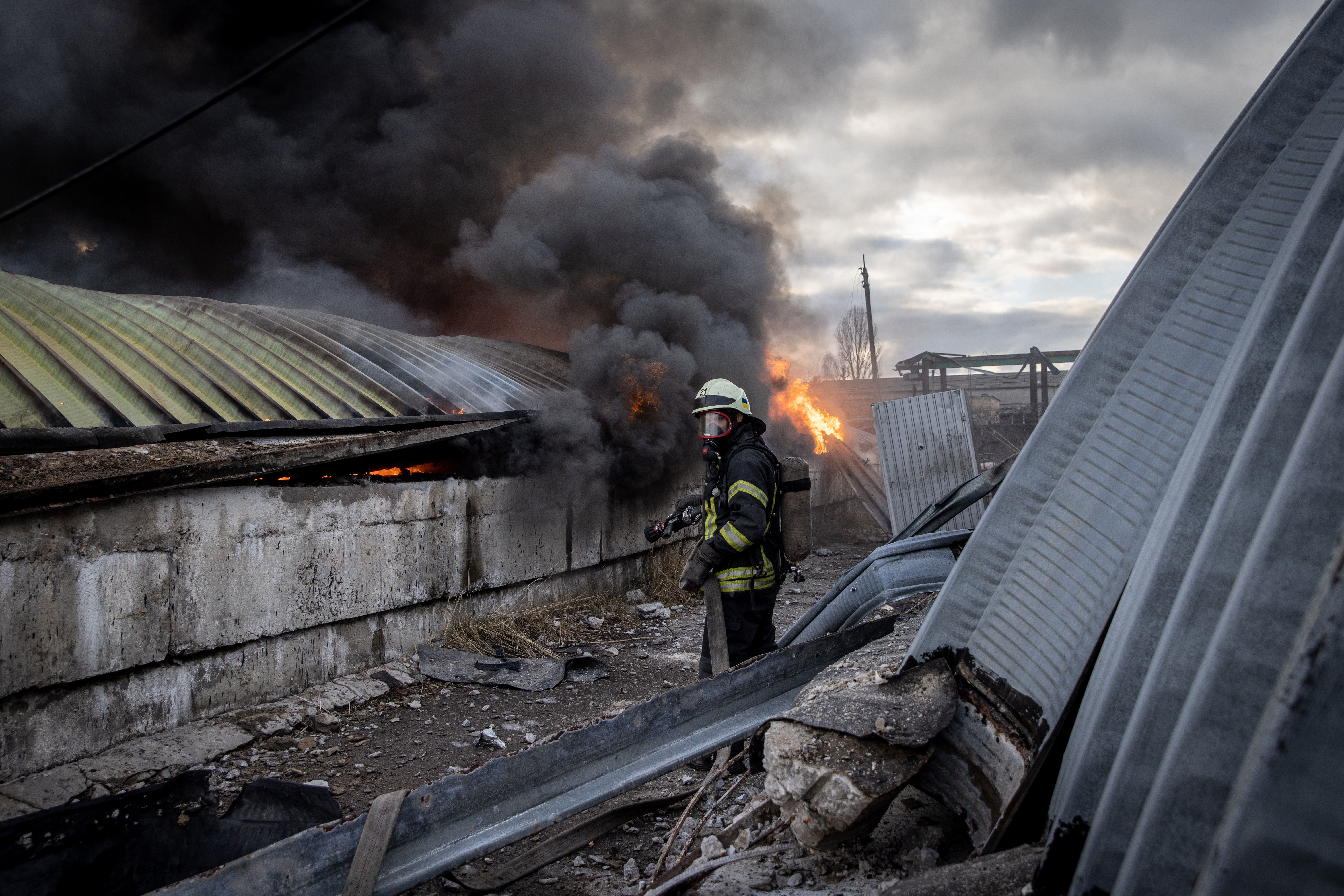 Firefighters try to extinguish a fire after a chemical warehouse was hit by Russian shelling on the eastern frontline near Kalynivka village on March 08, 2022, in Kyiv, Ukraine. 