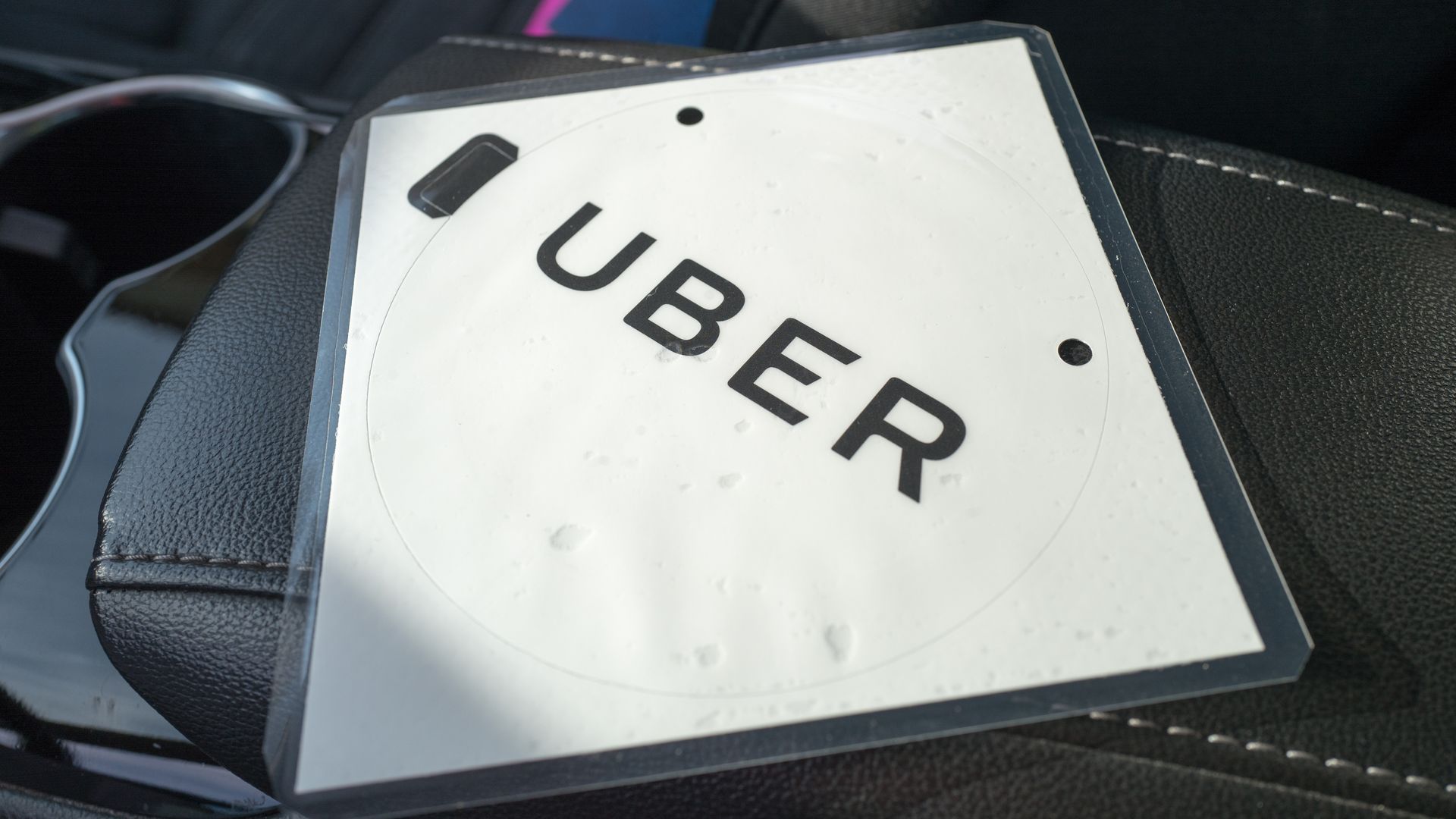 Laminated folder with the Uber logo on it