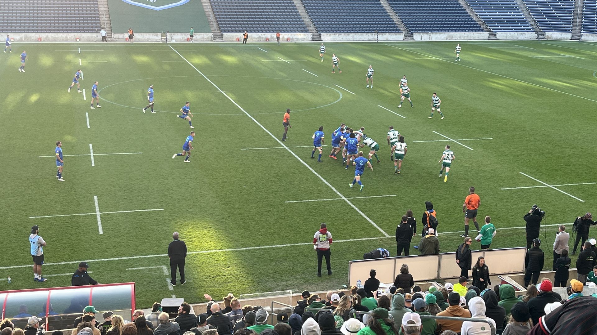 Photo of players on field playing rugby 