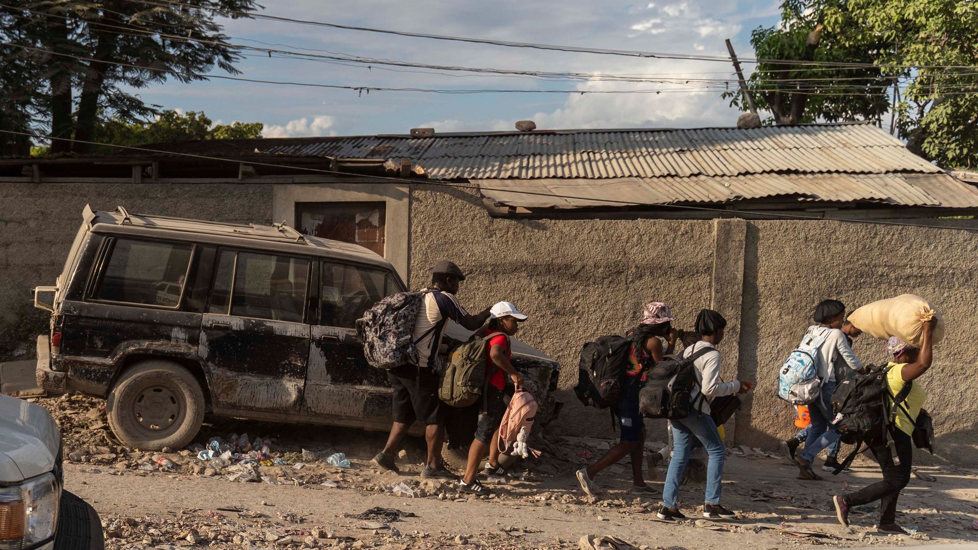 People flee their homes during an attack by armed gangs in the Carrefour Feuille neighborhood of Port-au-Prince, Haiti