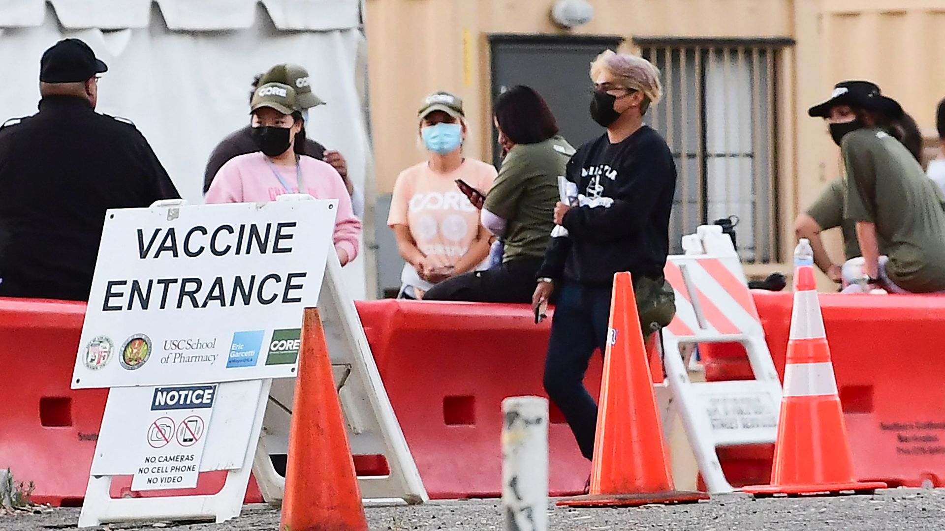 People wearing masks outside of a coronavirus vaccine site in Los Angeles on July 6.