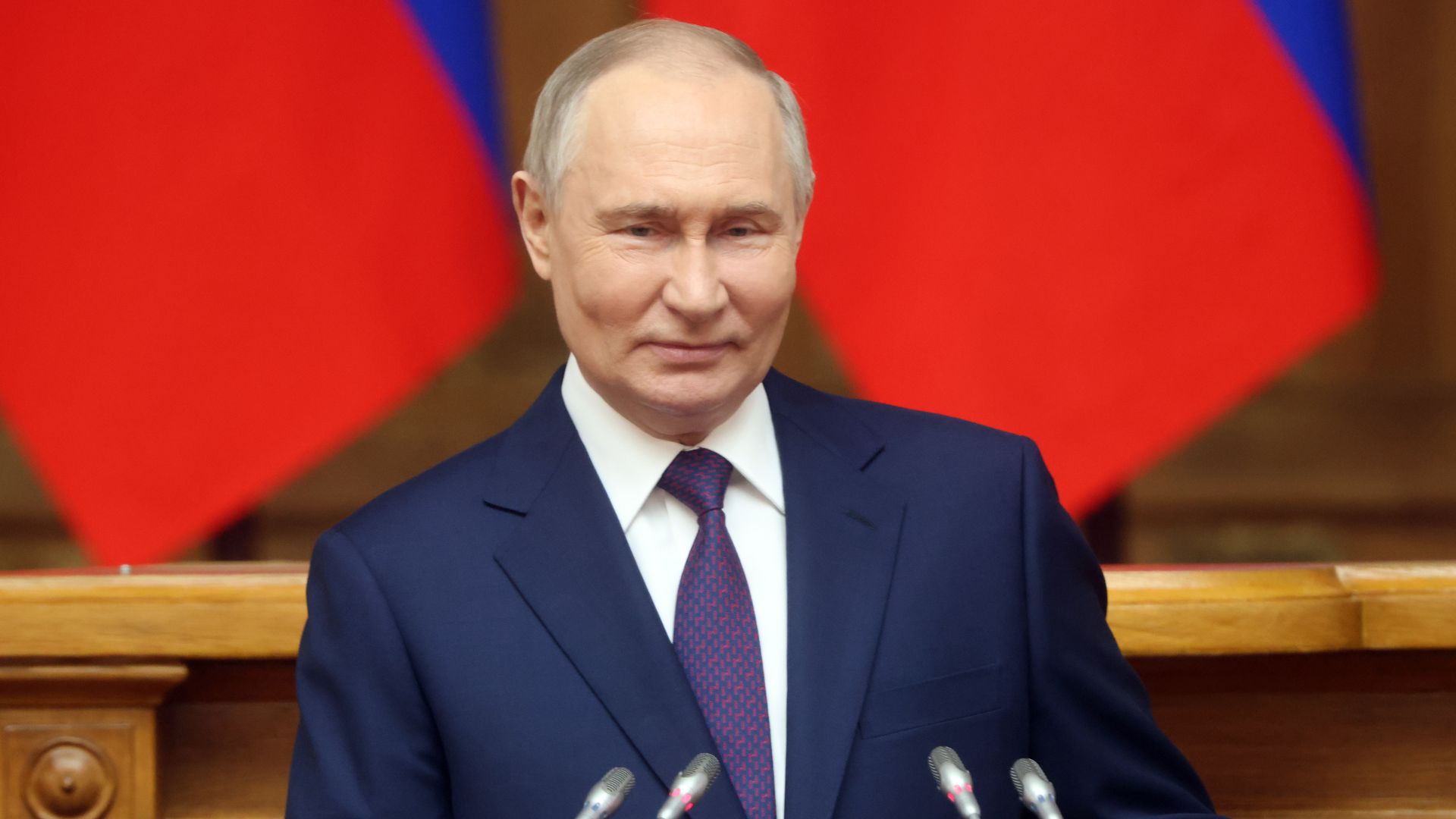 Russian President Vladimir Putin smiles during the Council of Legislators plenary session on April 26, 2024, in Saint Petersburg, Russia