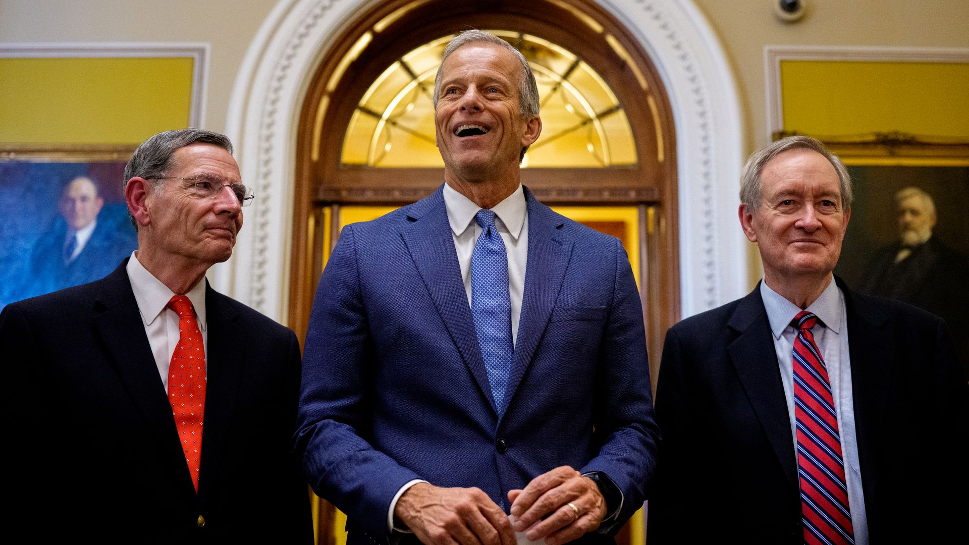 Senate Majority Leader John Thune (R-SD) (C), accompanied by Sen. John Barrasso (R-WY) (L) and Sen. Mike Crapo (R-ID) (R), speaks to reporters off the Senate floor after the Senate passes President Donald Trump's so-called "One, Big, Beautiful Bill," Act