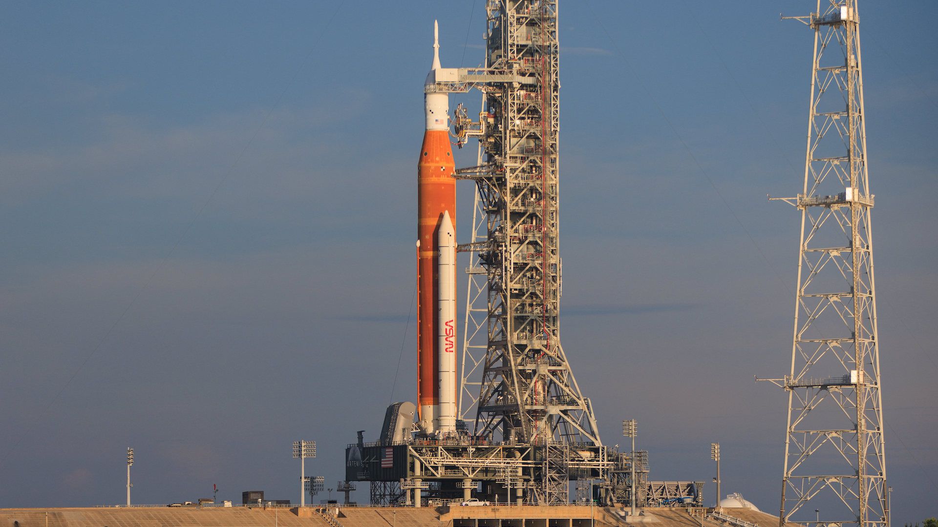 The Space Launch System rocket standing on the launch pad in daylight