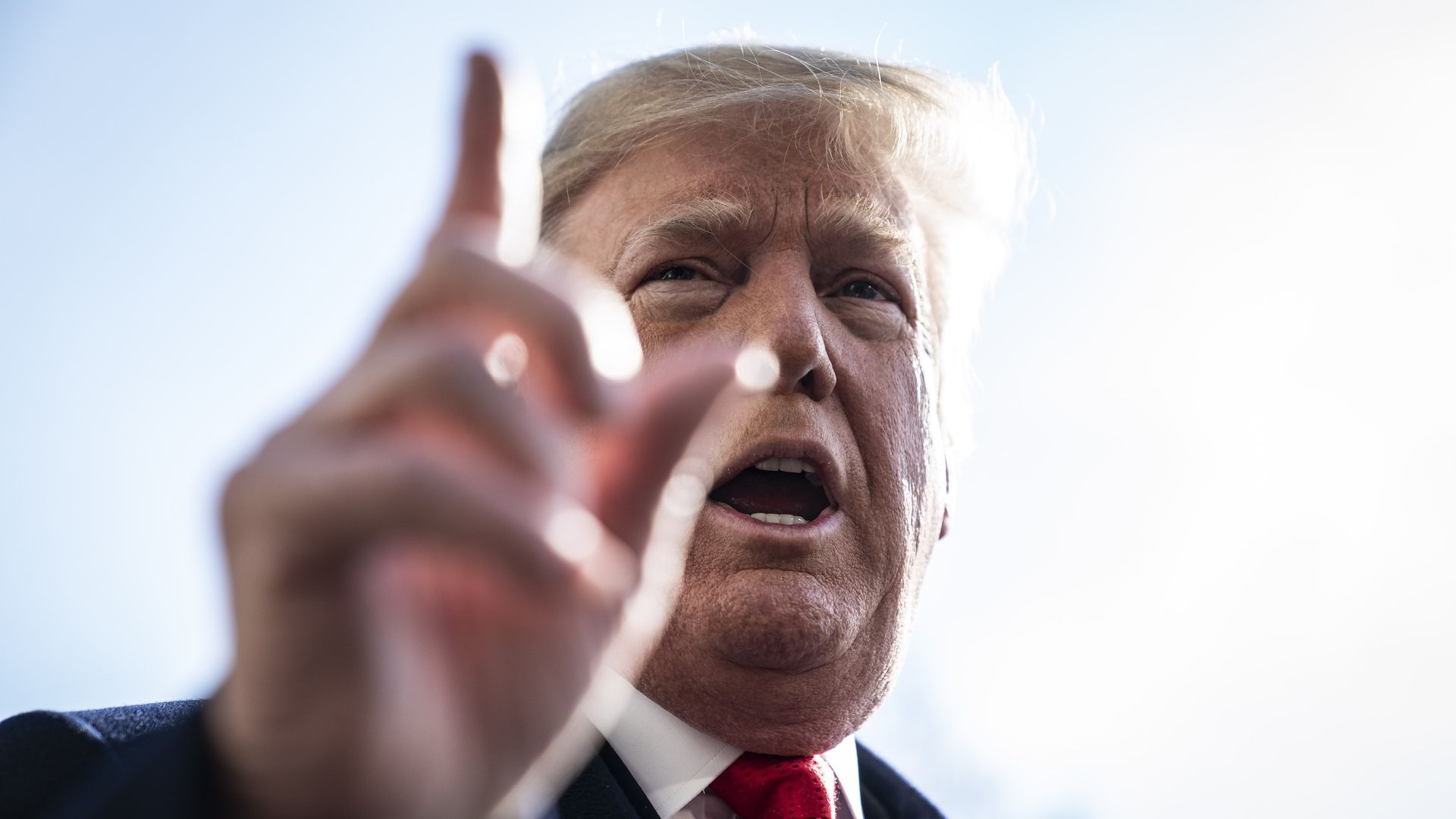 A close up on Donald Trump, with his hand gesturing in the foreground