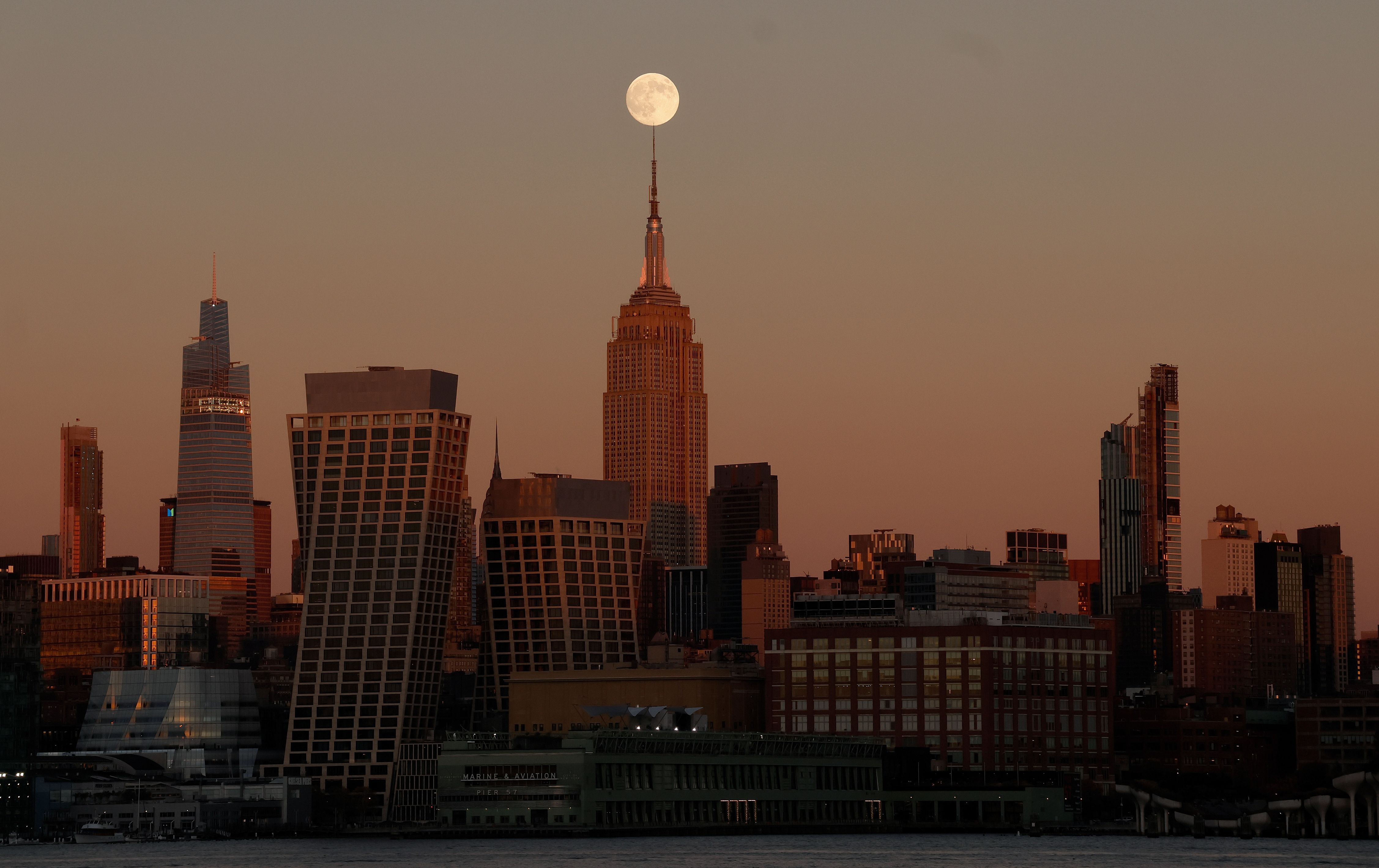 HOBOKEN, NJ - NOVEMBER 4: The Beaver Moon rises behind the Empire State Building as the sun sets in New York City on November 4, 2025, as seen from Hoboken, New Jersey. (Photo by Gary Hershorn/Getty Images)