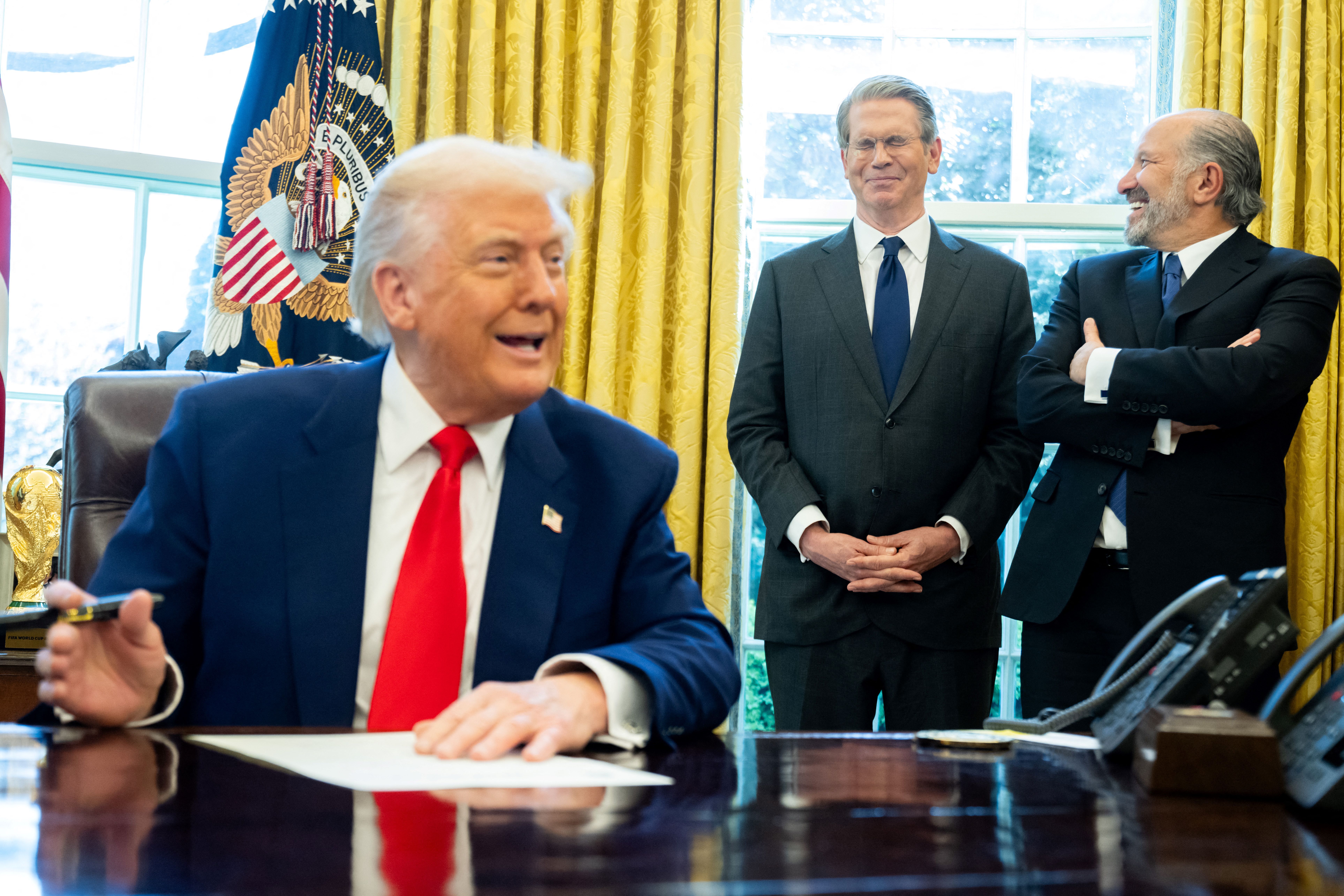 Treasury Secretary Scott Bessent and Commerce Secretary Howard Lutnick look on as President Trump signs executive orders yesterday. 