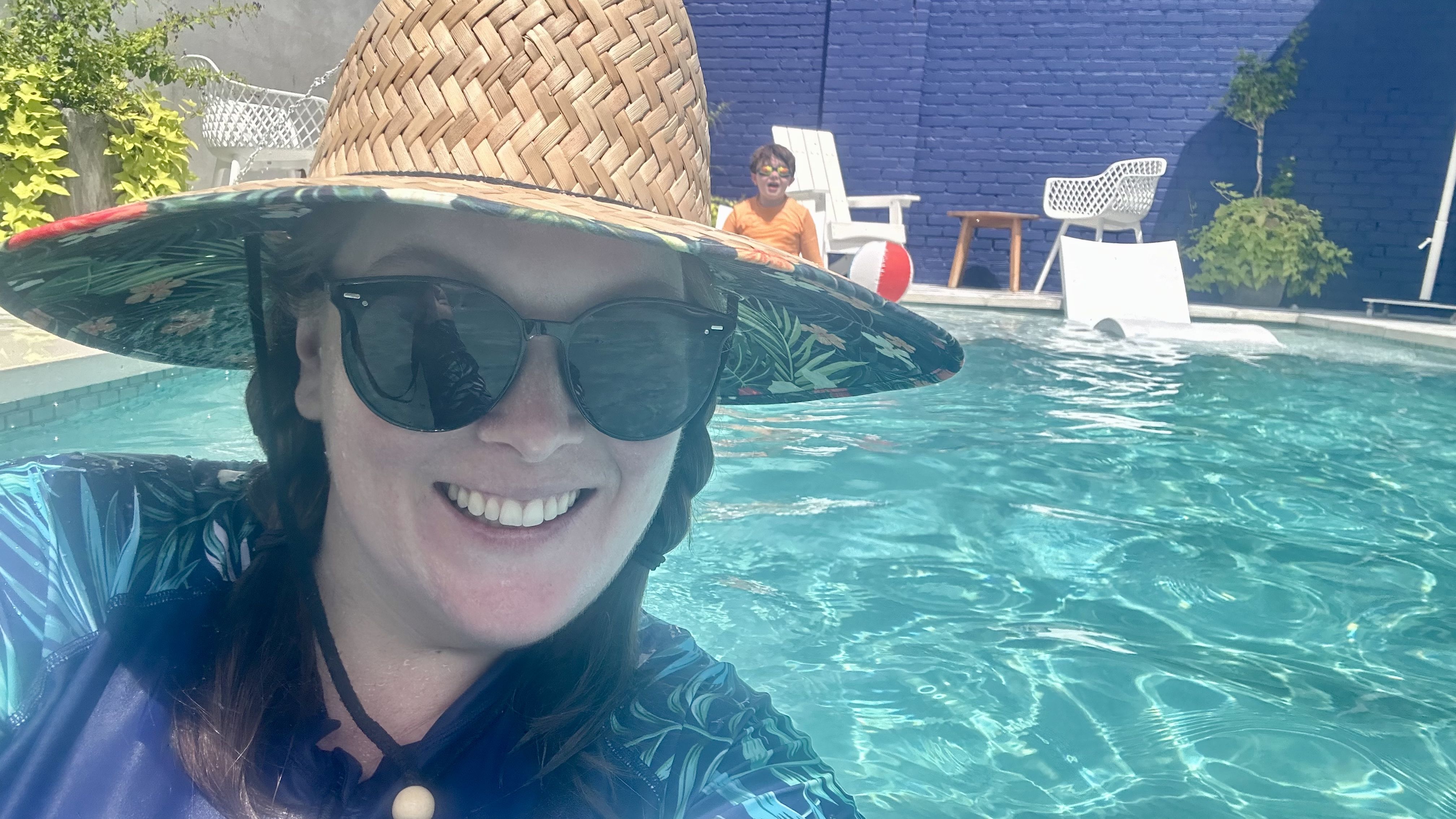 Photo shows Carlie in a hat in the pool.